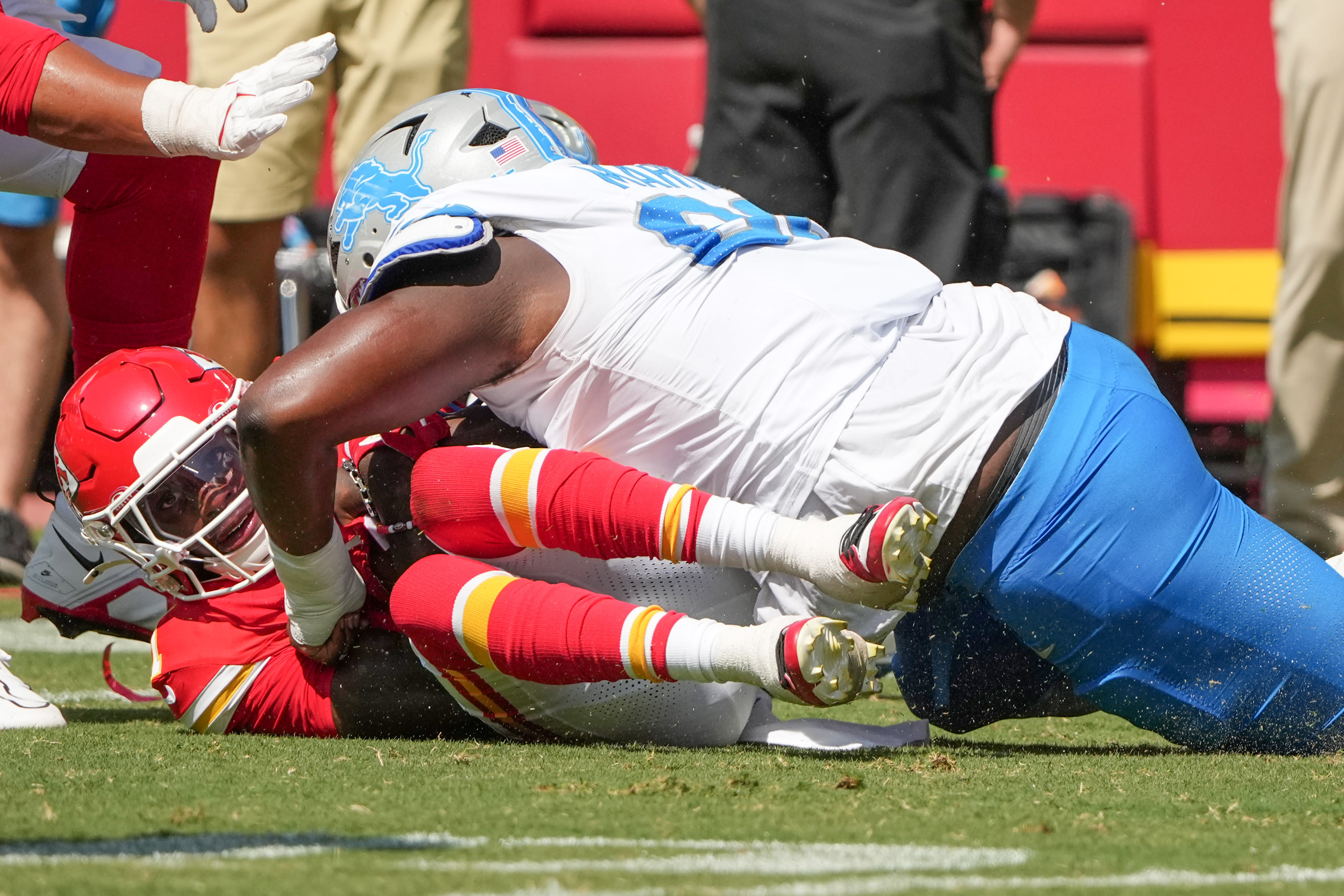 Aug 17, 2024; Kansas City, Missouri, USA; Kansas City Chiefs wide receiver Xavier Worthy (1) runs the ball and is tackled by Detroit Lions defensive tackle Brodric Martin (99) during the game at GEHA Field at Arrowhead Stadium. Mandatory Credit: Denny Medley-USA TODAY Sports
