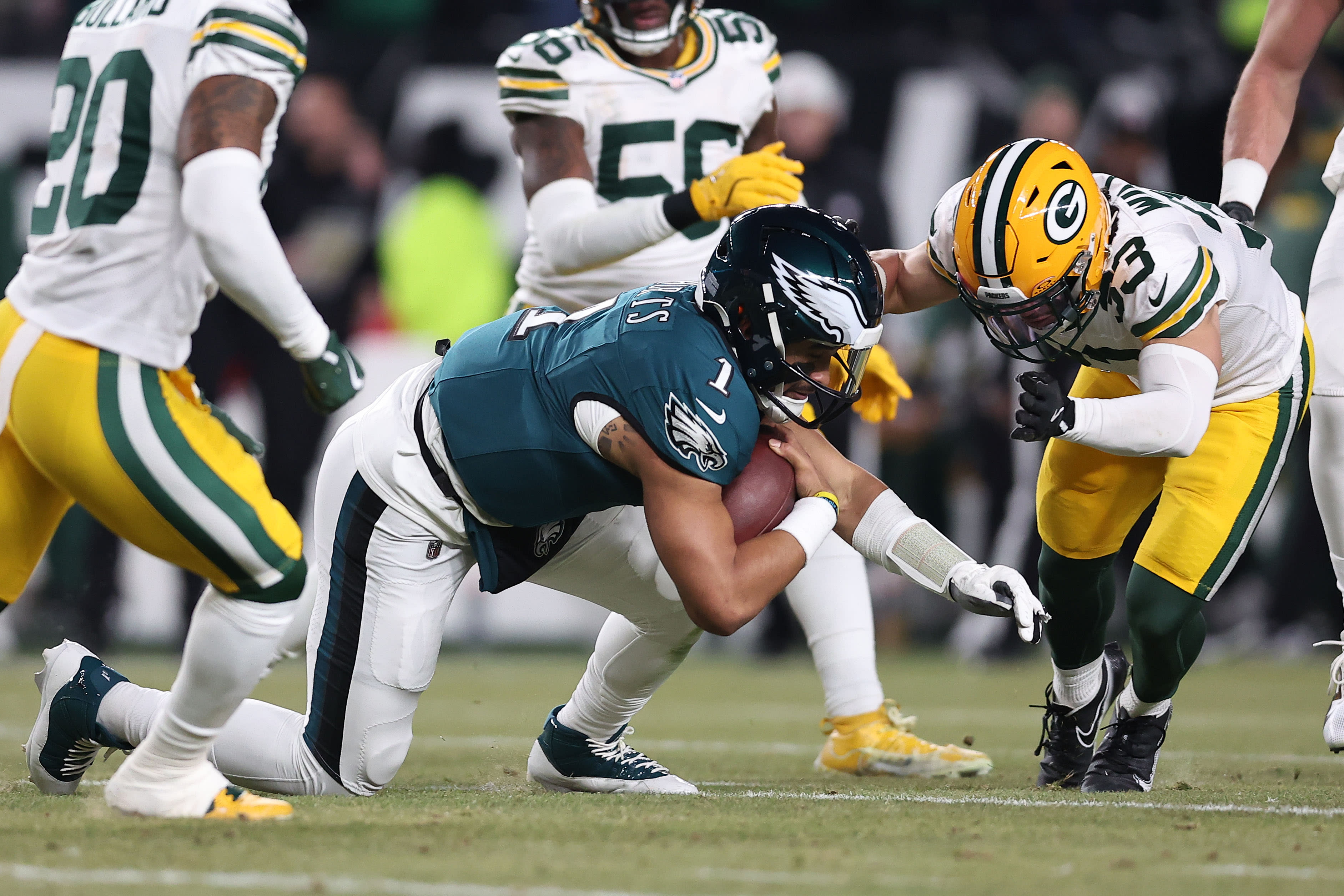 Jan 12, 2025; Philadelphia, Pennsylvania, USA; Philadelphia Eagles quarterback Jalen Hurts (1) rushes the ball agaistn Green Bay Packers safety Evan Williams (33) during the first half in an NFC wild card game at Lincoln Financial Field. Mandatory Credit: Bill Streicher-Imagn Images
