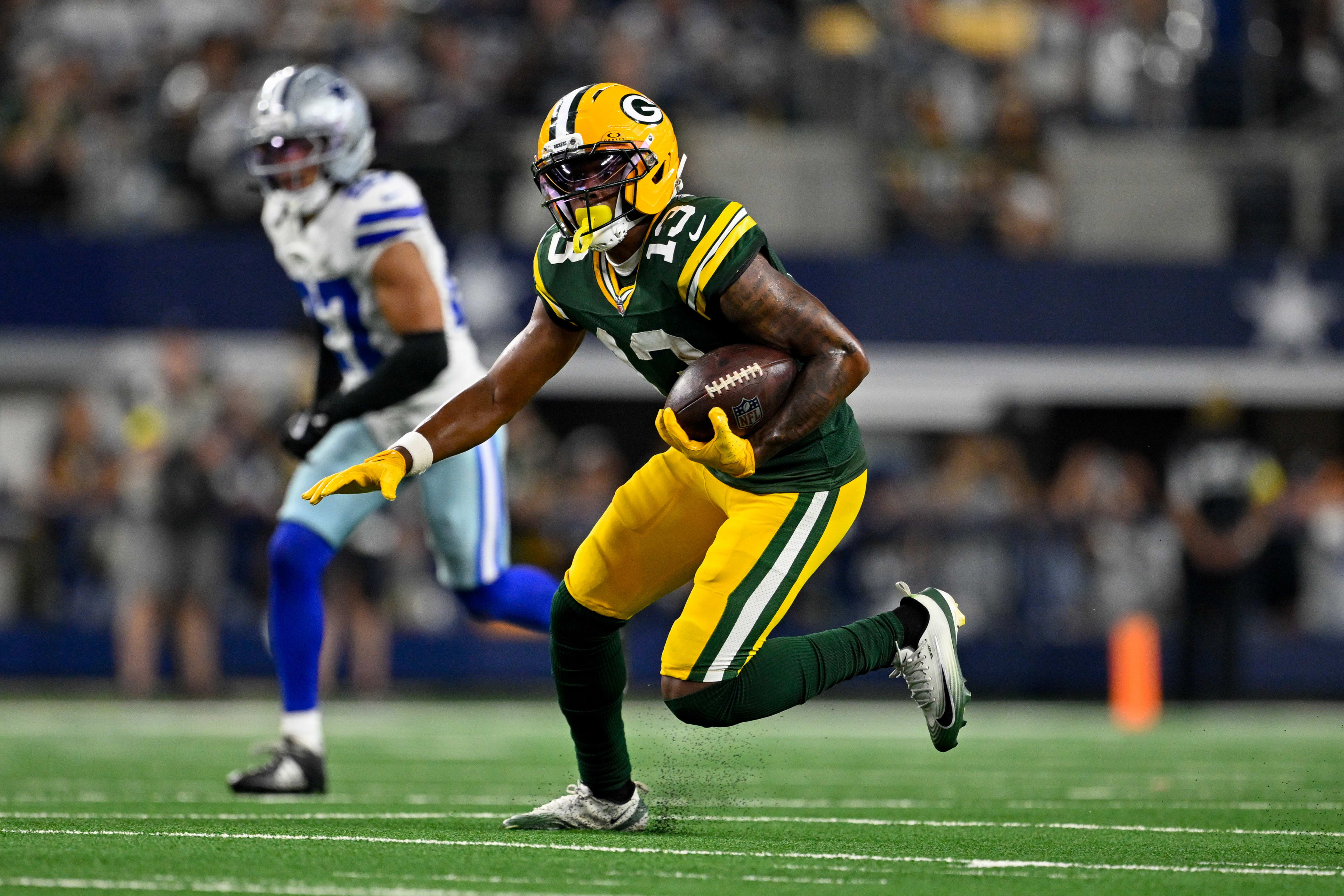 Sep 28, 2025; Arlington, Texas, USA; Green Bay Packers wide receiver Dontayvion Wicks (13) runs with the ball during the game between the Dallas Cowboys and the Green Bay Packers at AT&T Stadium. Mandatory Credit: Jerome Miron-Imagn Images