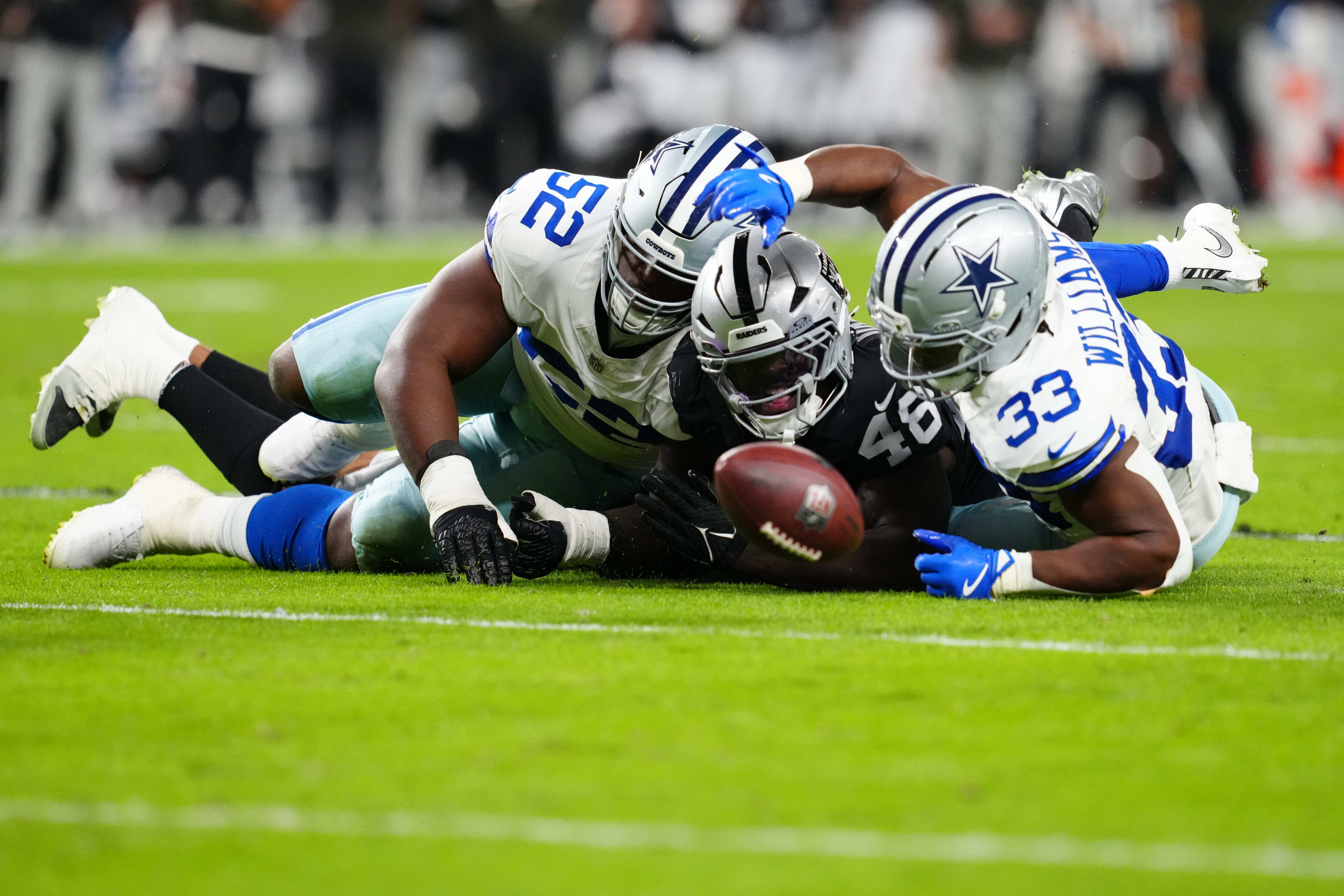 Nov 17, 2025; Paradise, Nevada, USA; Las Vegas Raiders linebacker Jamin Davis (48) battles with Dallas Cowboys guard Tyler Booker (52) and running back Javonte Williams (33) for the loose ball during the first half at Allegiant Stadium.