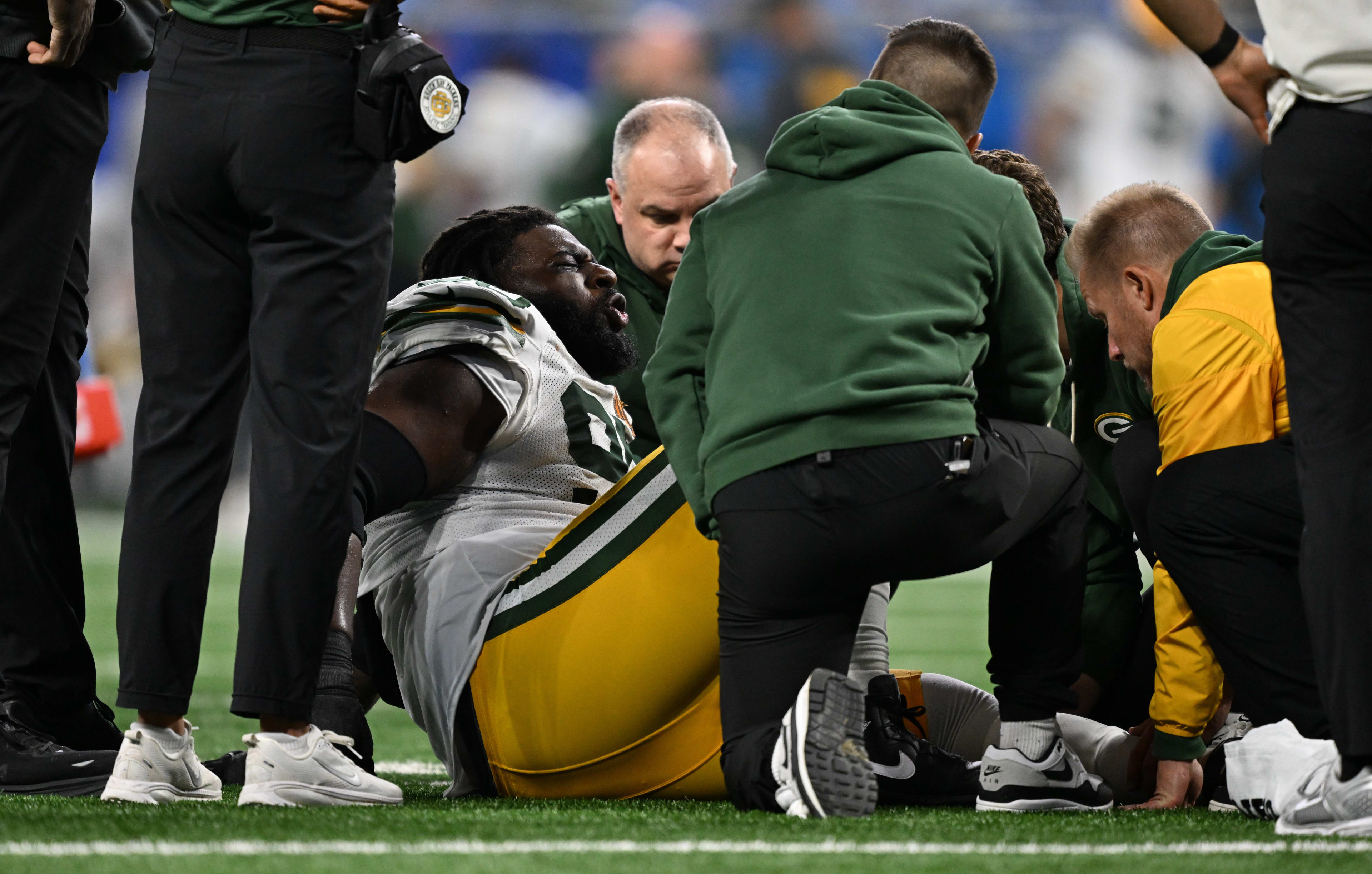 Nov 27, 2025; Detroit, Michigan, USA; Green Bay Packers defensive tackle Devonte Wyatt (95) is looked at after an injury against the Detroit Lions during the third quarter at Ford Field.