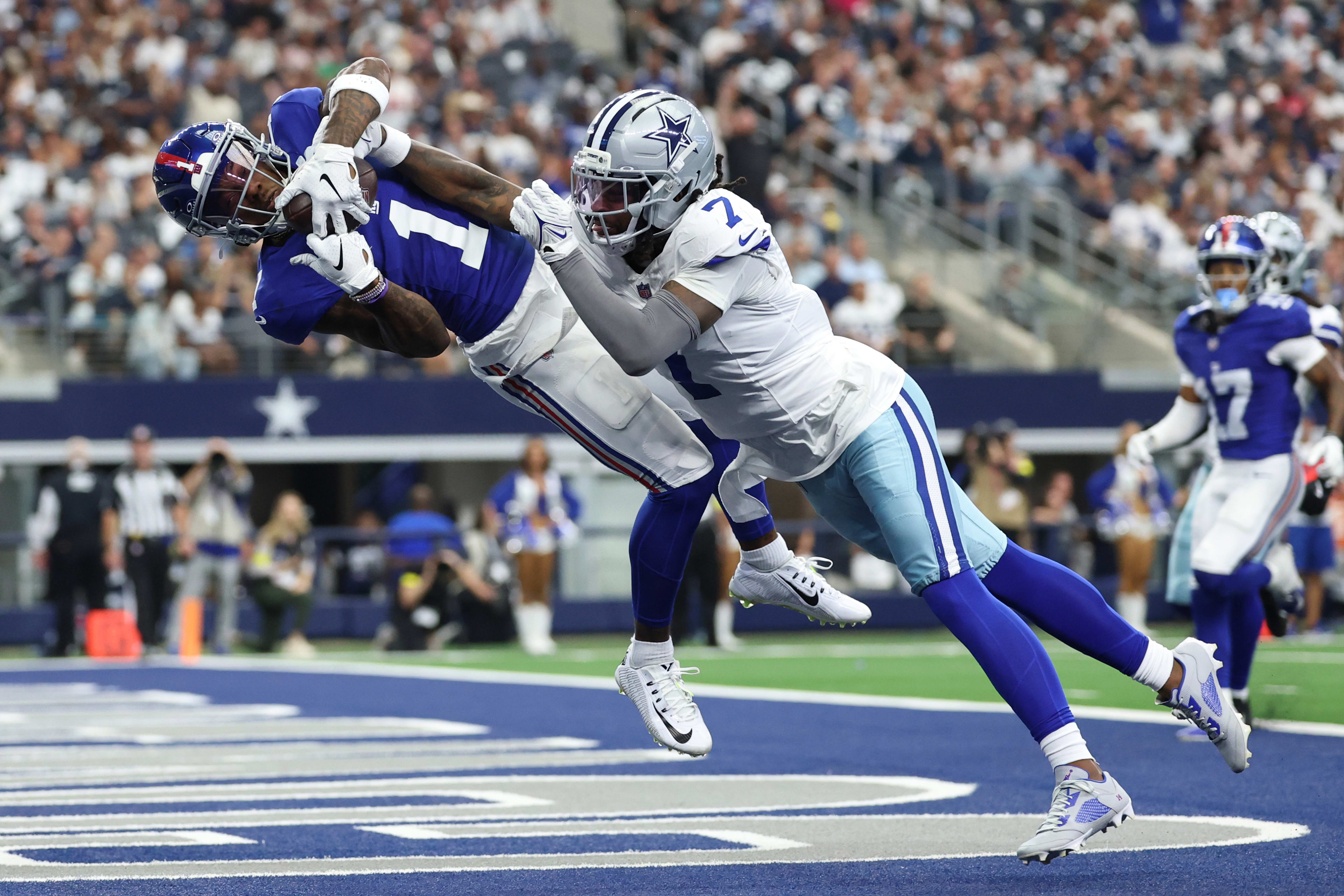 New York Giants wide receiver Malik Nabers (1) makes a catch for a touchdown against Dallas Cowboys cornerback Trevon Diggs (7) during the second quarter at AT&T Stadium.
