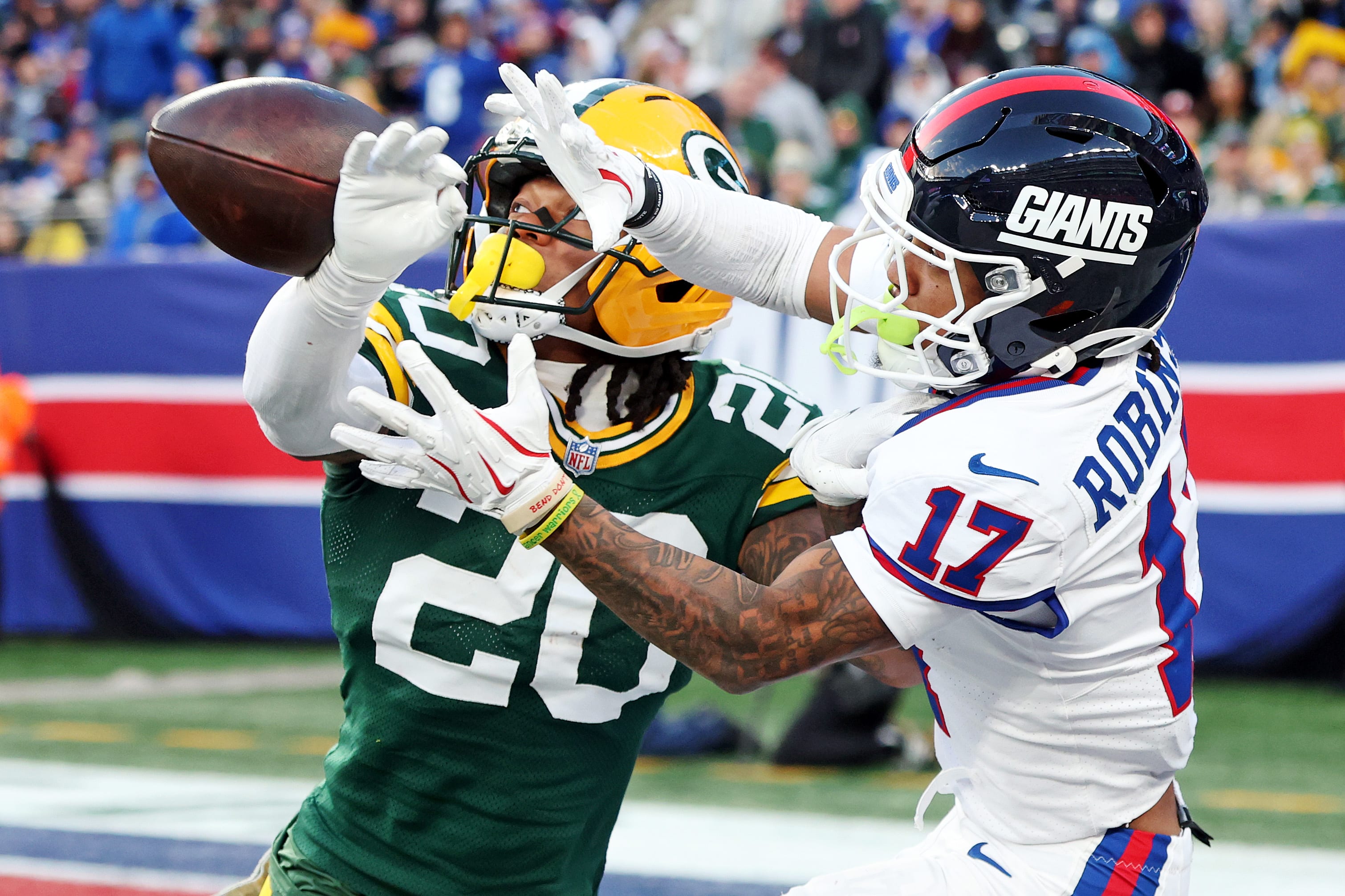 Nov 16, 2025; East Rutherford, New Jersey, USA; Green Bay Packers safety Javon Bullard (20) breaks up a pass intended for New York Giants wide receiver Wan'Dale Robinson (17) during the fourth quarter at MetLife Stadium.