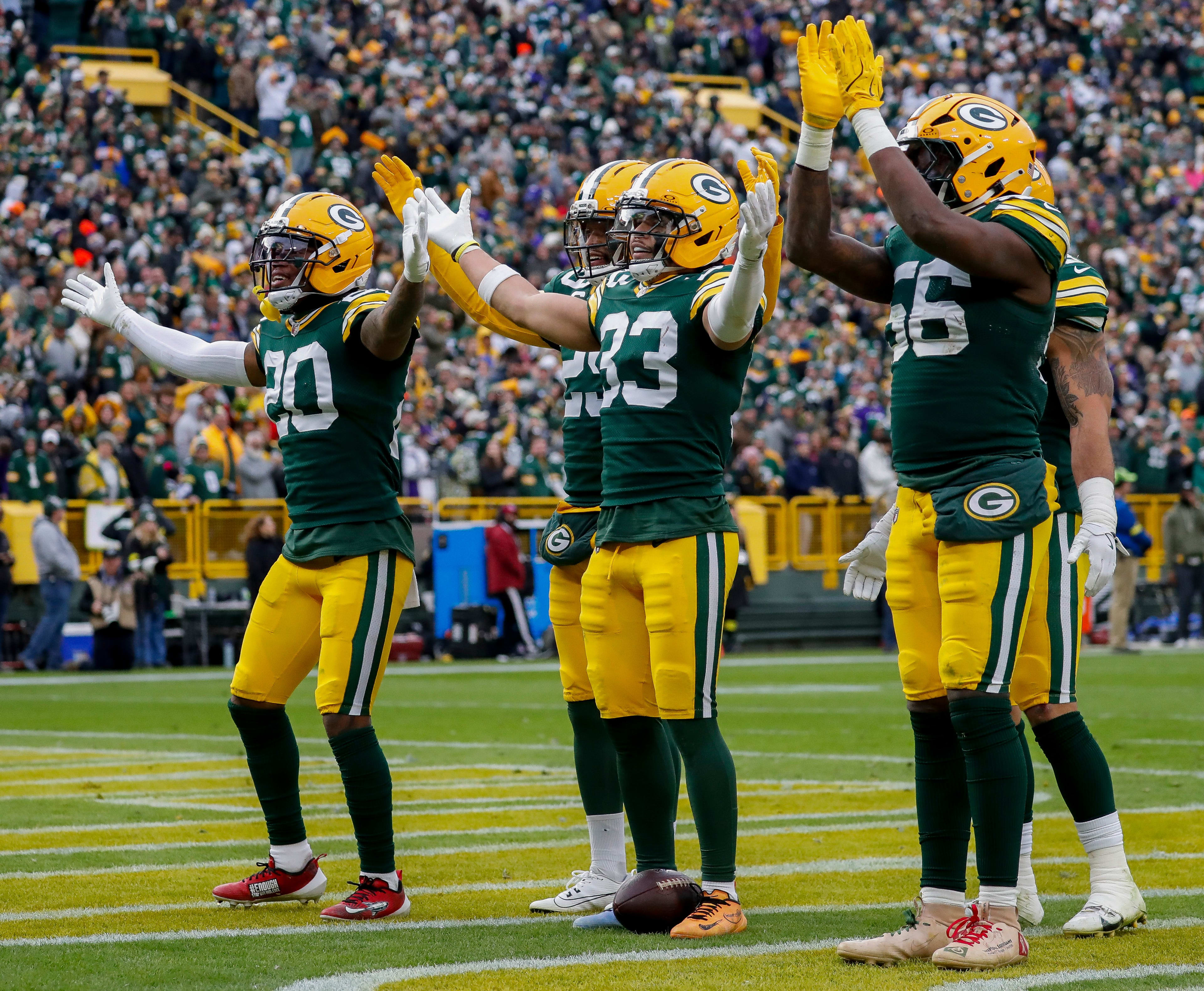 Green Bay Packers safeties Javon Bullard (20), Evan Williams (33), and Xavier McKinney (29) and linebacker Edgerrin Cooper (56) lead Packers fans in a mock “Skol” chant after Williams intercepts a pass against the Minnesota Vikings on Sunday, November 23, 2025, at Lambeau Field in Green Bay, Wis. The Packers won the game, 23-6.