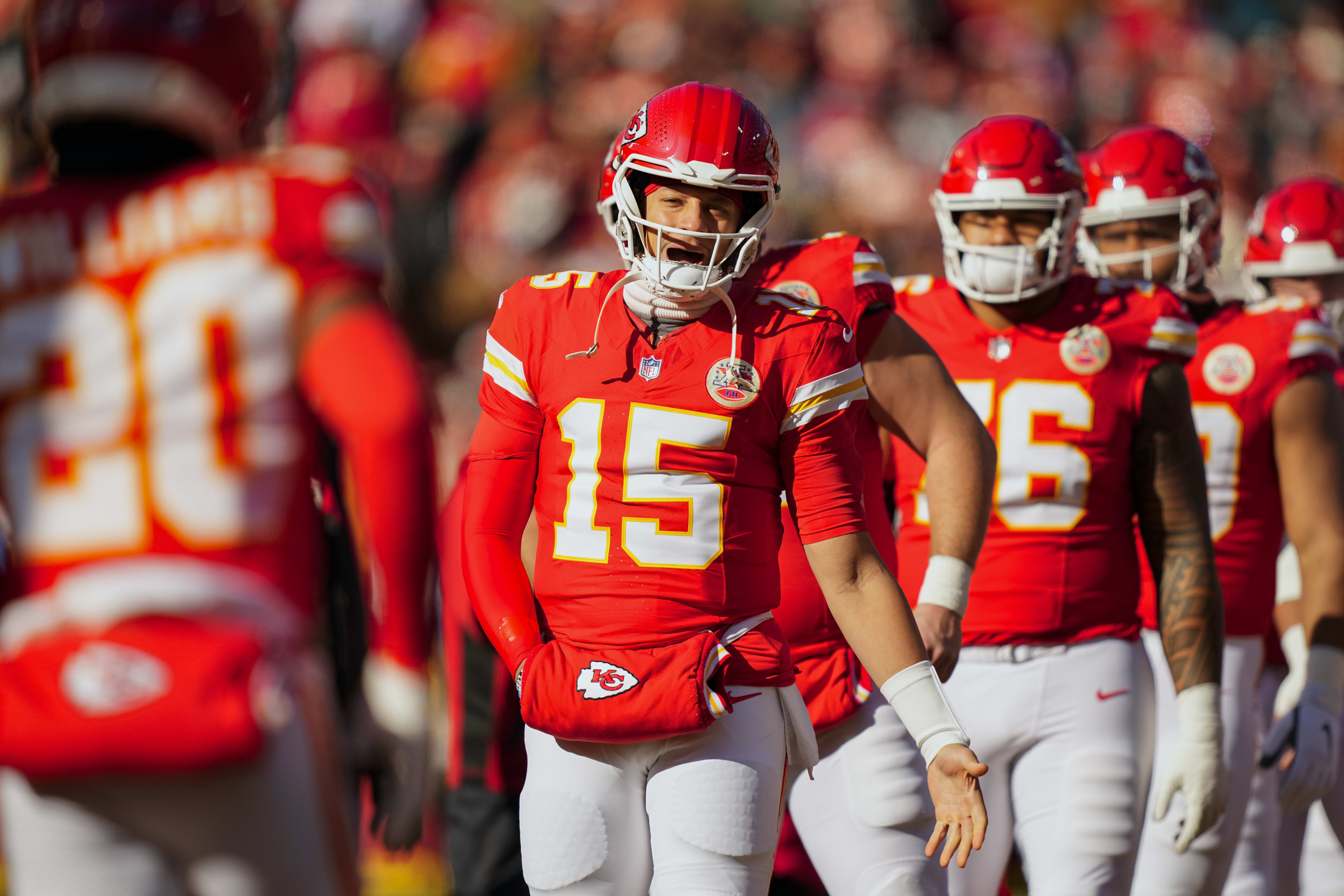 Dec 14, 2025; Kansas City, Missouri, USA; Kansas City Chiefs quarterback Patrick Mahomes (15) greets teammates prior to a game against the Los Angeles Chargers at GEHA Field at Arrowhead Stadium. 
