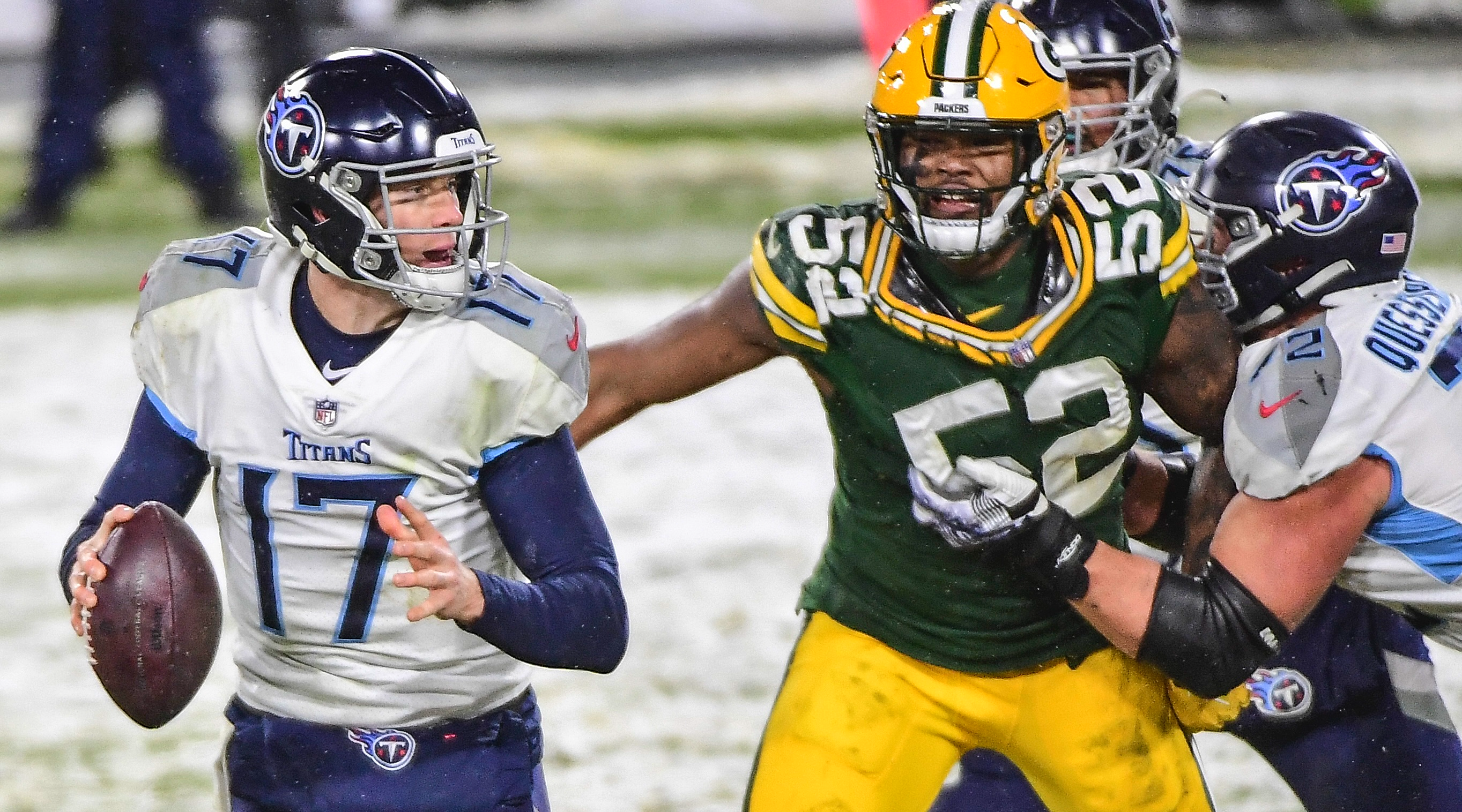 Dec 27, 2020; Green Bay, Wisconsin, USA; Tennessee Titans quarterback Ryan Tannehill (17) is pressured by Green Bay Packers linebacker Rashan Gary (52) in the fourth quarter at Lambeau Field. Mandatory Credit: Benny Sieu-USA TODAY Sports