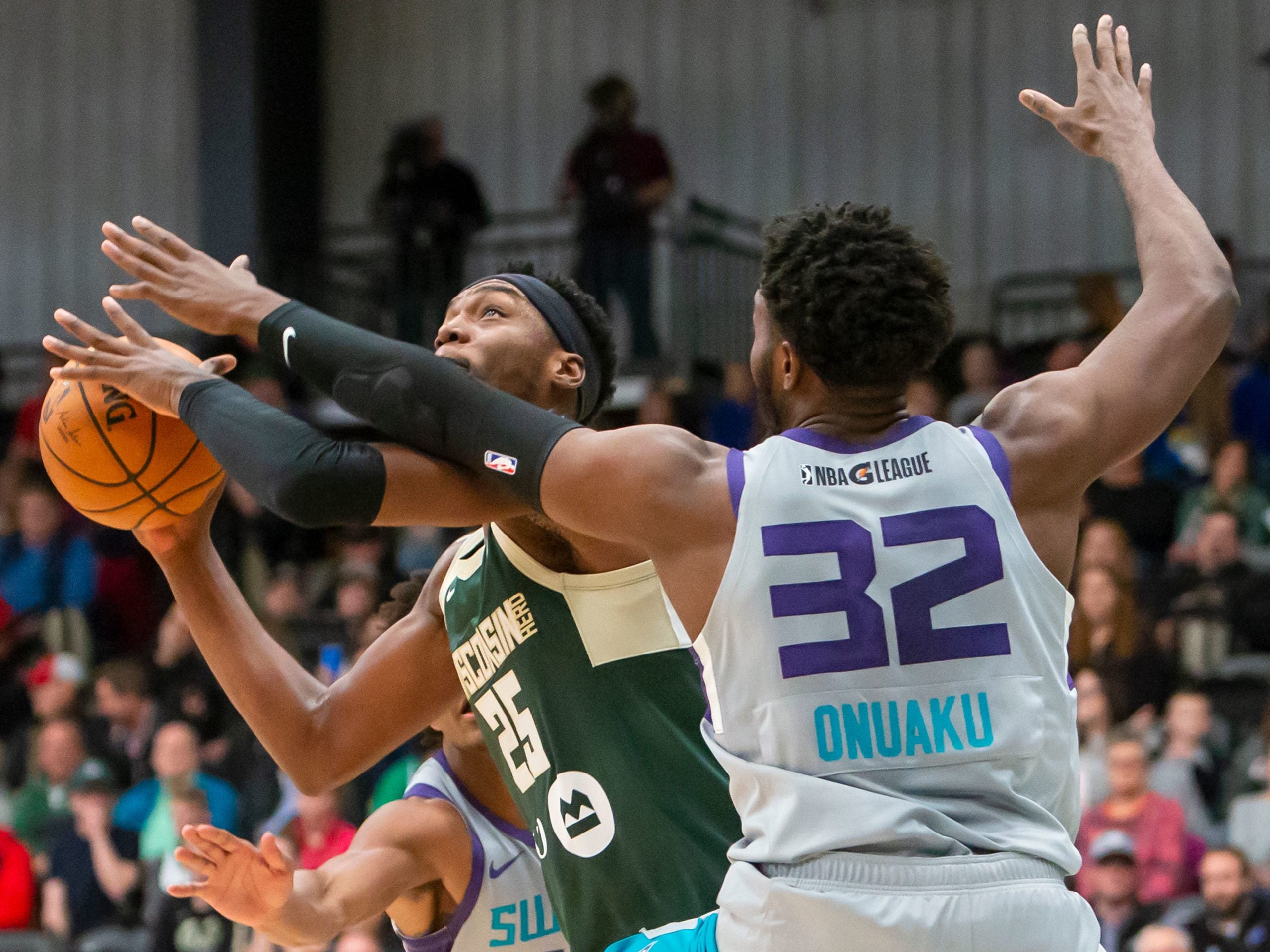 Onuaku defends layup attempt.