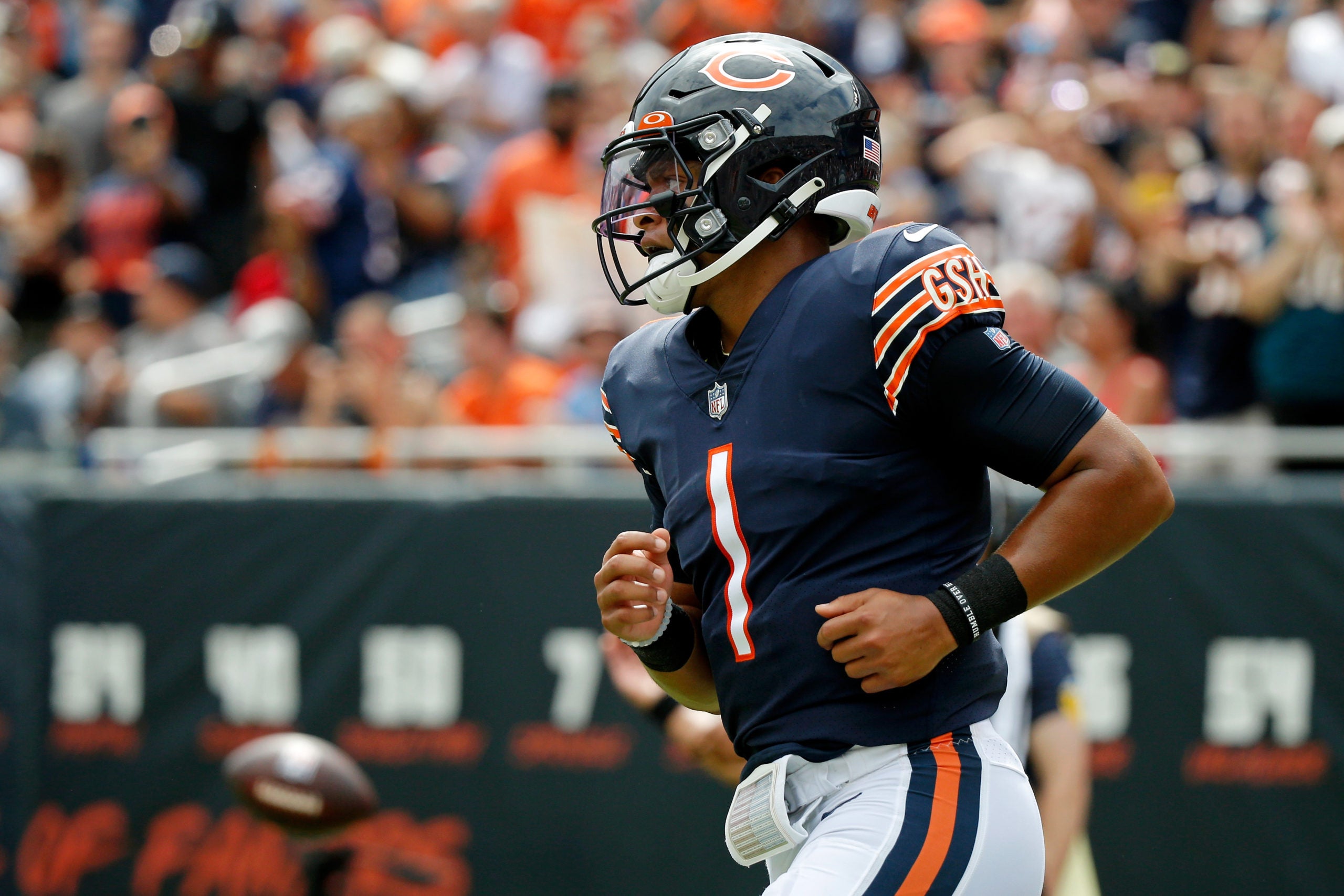 Aug 21, 2021; Chicago, Illinois, USA; Chicago Bears quarterback Justin Fields (1) after running the ball against the Buffalo Bills during the second half at Soldier Field. Mandatory Credit: Jon Durr-USA TODAY Sports