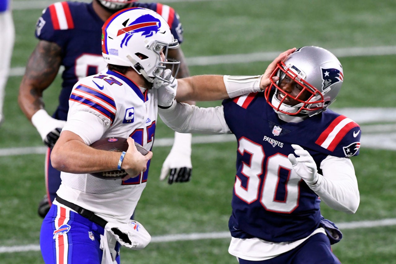 Dec 28, 2020; Foxborough, Massachusetts, USA; Buffalo Bills quarterback Josh Allen (17) rushes against New England Patriots cornerback Jason McCourty (30) during the second quarter at Gillette Stadium. Mandatory Credit: Brian Fluharty-USA TODAY Sports