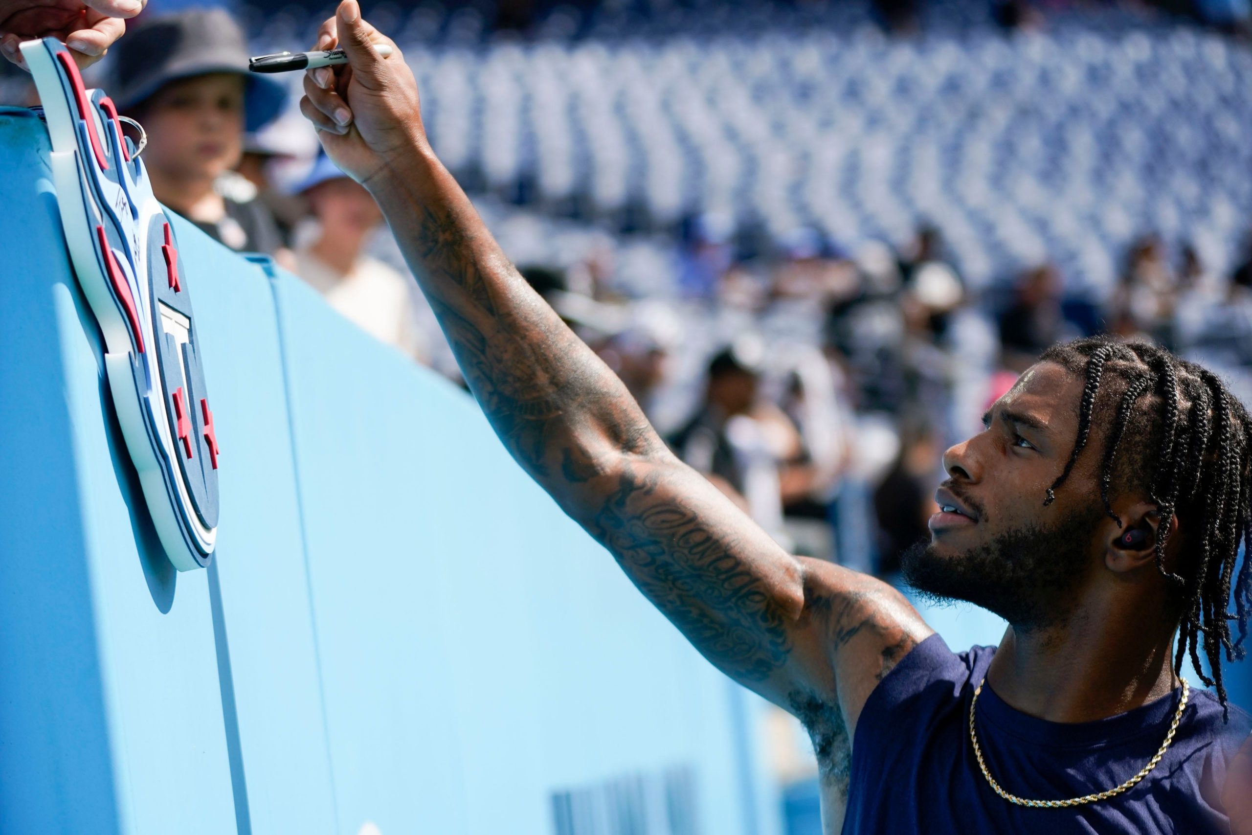 Tennessee Titans cornerback Kristian Fulton (26) signs autographs for fans before facing the Las Vegas Raiders at Nissan Stadium Sunday, Sept. 25, 2022, in Nashville, Tenn. Nfl Las Vegas Raiders At Tennessee Titans