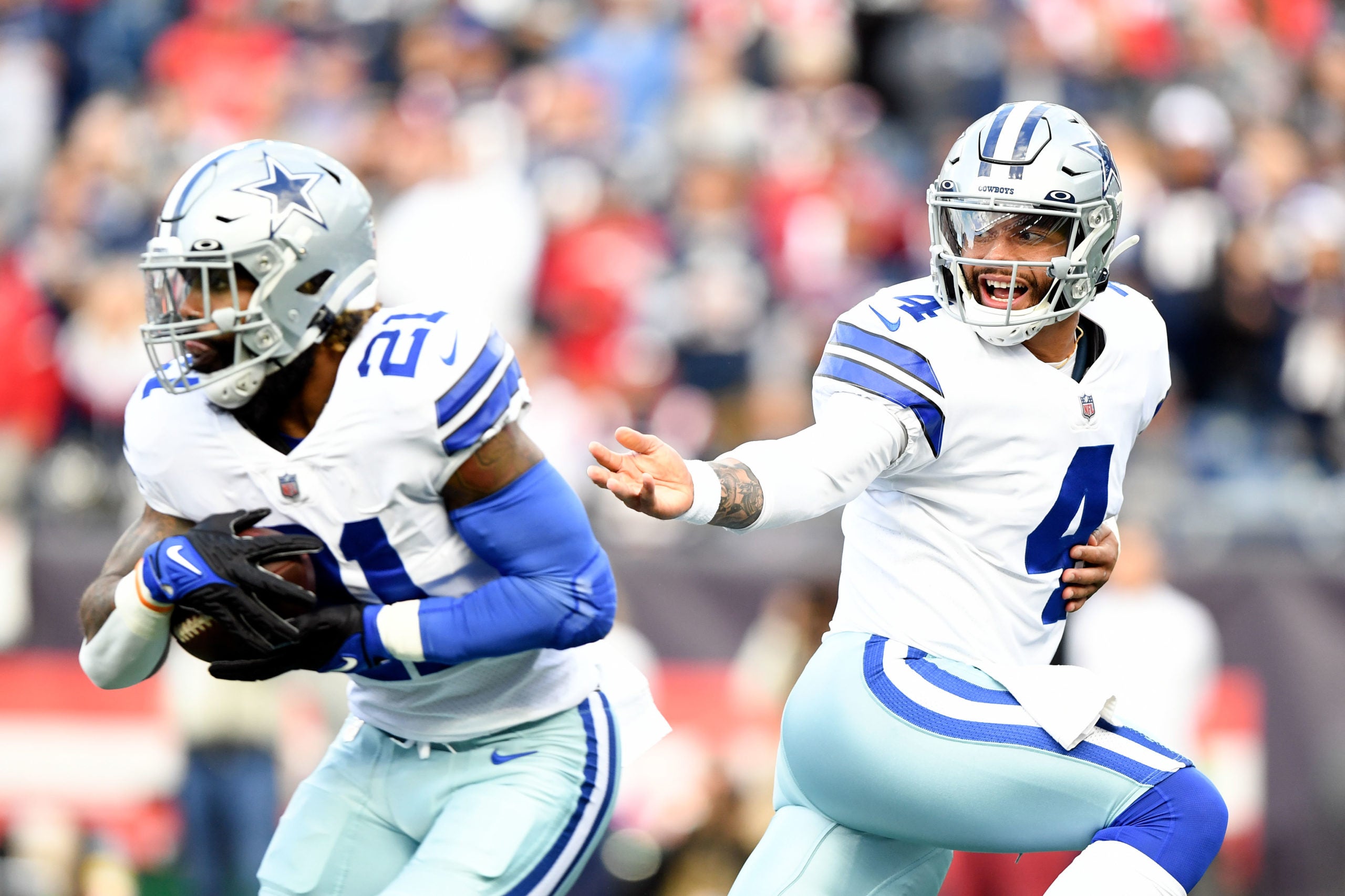 Oct 17, 2021; Foxborough, Massachusetts, USA; Dallas Cowboys quarterback Dak Prescott (4) hands the ball off to running back Ezekiel Elliott (21) during the first half of a game against the New England Patriots at Gillette Stadium. Mandatory Credit: Brian Fluharty-USA TODAY Sports