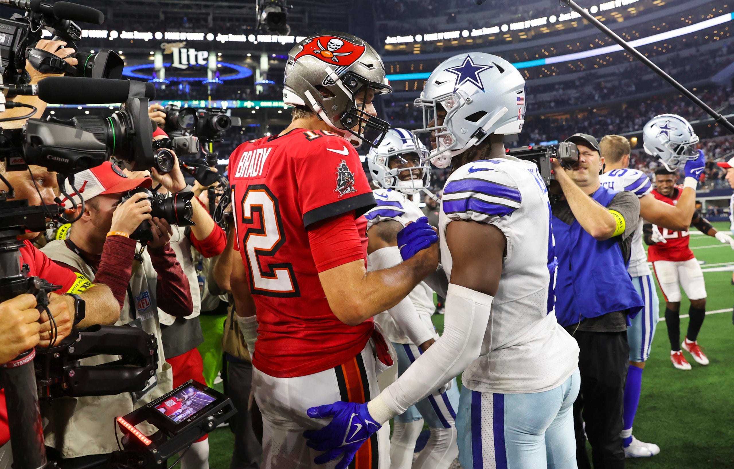 Sep 11, 2022; Arlington, Texas, USA;  Tampa Bay Buccaneers quarterback Tom Brady (12) shakes hands with Dallas Cowboys safety Donovan Wilson (6) after the game at AT&T Stadium. Mandatory Credit: Kevin Jairaj-USA TODAY Sports