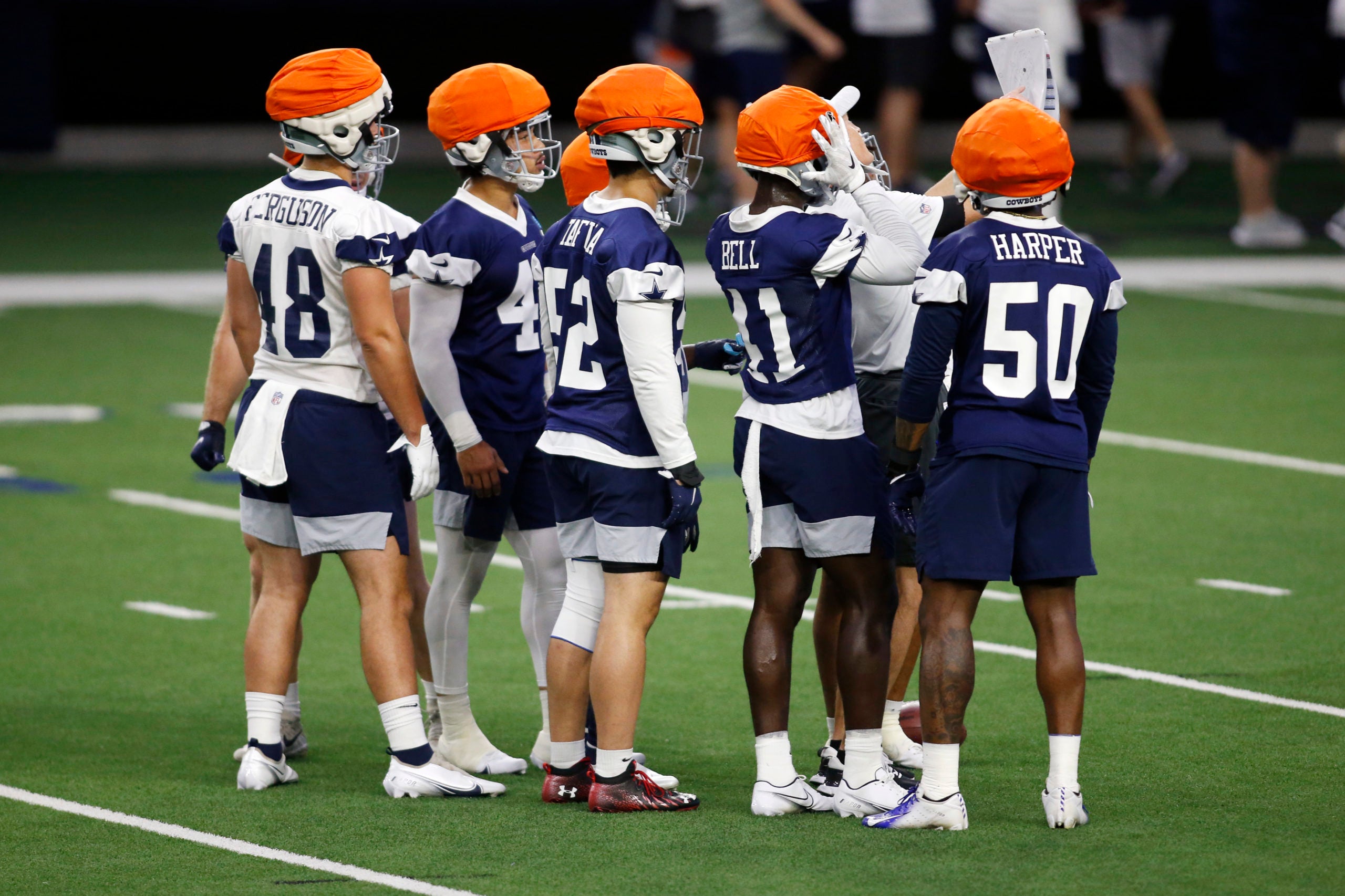 Jun 14, 2022; Arlington, Texas, USA; Dallas Cowboys players wearing the new Guardian Cap helmet at the Ford Center at the Star Training Facility in Frisco, Texas. Mandatory Credit: Tim Heitman-USA TODAY Sports