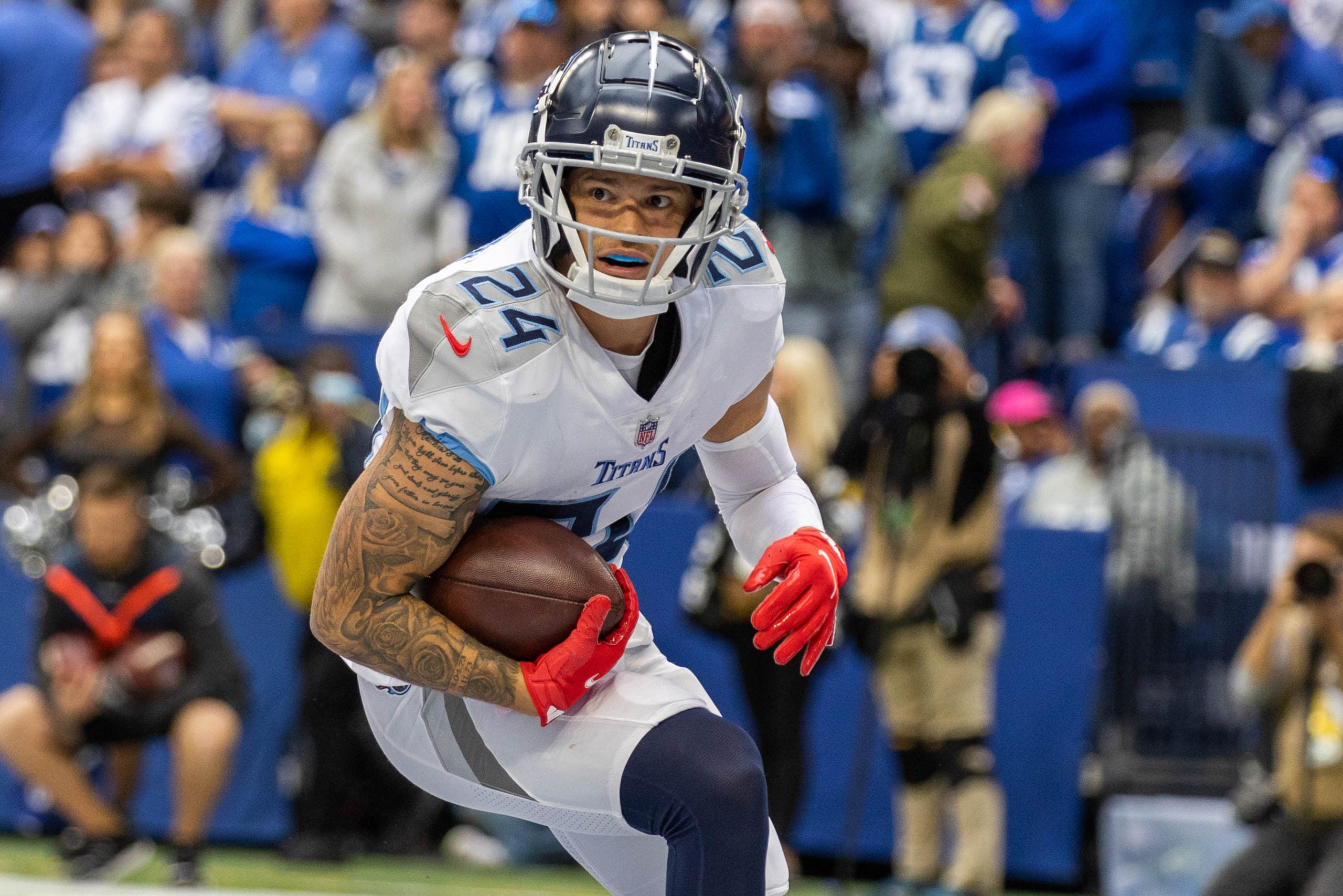 Oct 31, 2021; Indianapolis, Indiana, USA; Tennessee Titans cornerback Elijah Molden (24) intercepts the ball for a touchdown in the second half against the Indianapolis Colts at Lucas Oil Stadium. Mandatory Credit: Trevor Ruszkowski-USA TODAY Sports