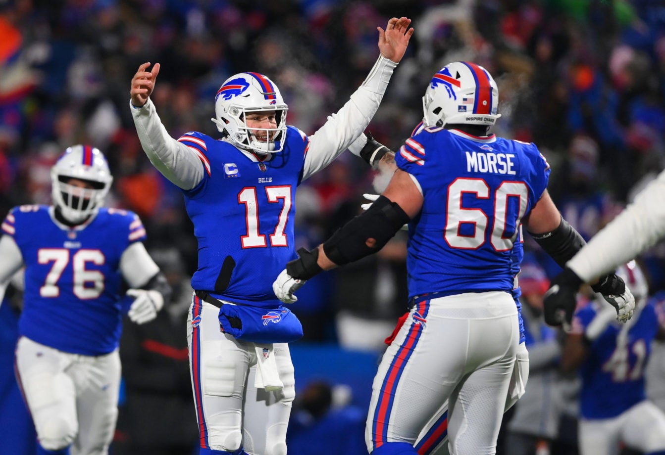 Jan 15, 2022; Orchard Park, New York, USA; Buffalo Bills quarterback Josh Allen (17) celebrates a touchdown pass with center Mitch Morse (60) during the third quarter of the AFC Wild Card playoff game against the New England Patriots at Highmark Stadium. Mandatory Credit: Rich Barnes-USA TODAY Sports
