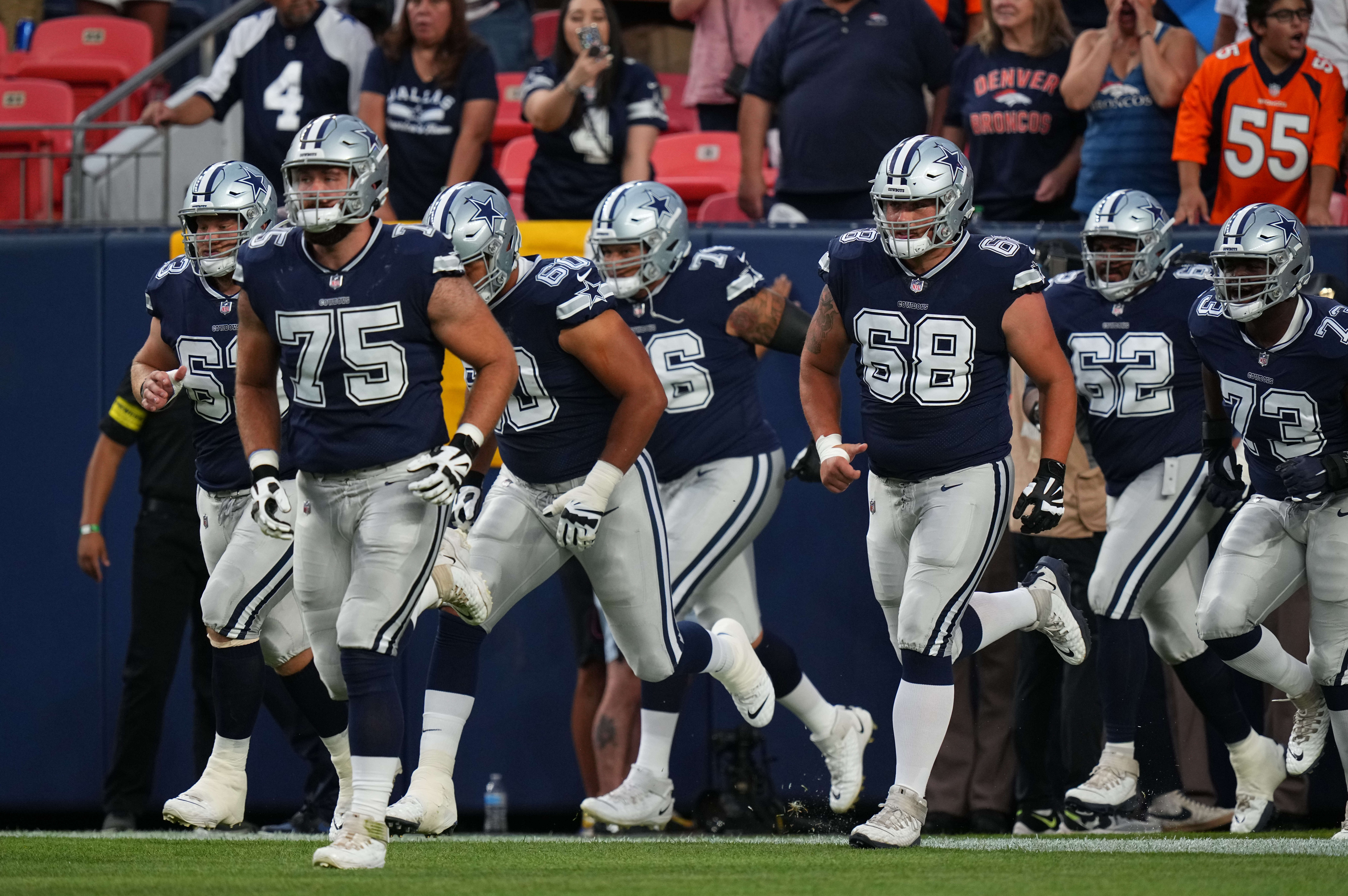 Aug 13, 2022; Denver, Colorado, USA; Members of the Dallas Cowboys prior to the preseason game against the Denver Broncos at Empower Field at Mile High. Mandatory Credit: Ron Chenoy-USA TODAY Sports