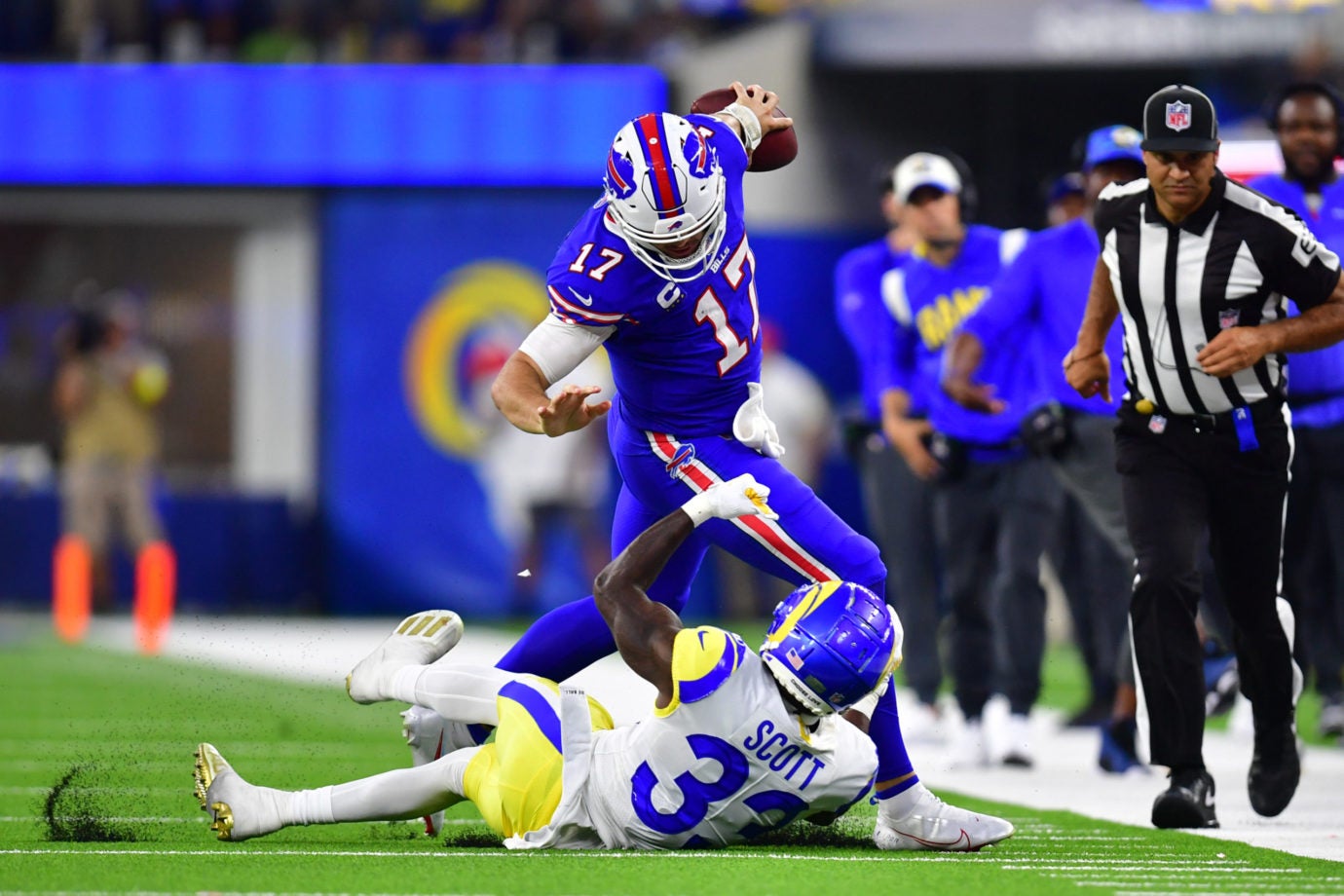 Sep 8, 2022; Inglewood, California, USA; Buffalo Bills quarterback Josh Allen (17) avoids a tackle from Los Angeles Rams safety Nick Scott (33) in the third quarter at SoFi Stadium. Mandatory Credit: Gary A. Vasquez-USA TODAY Sports