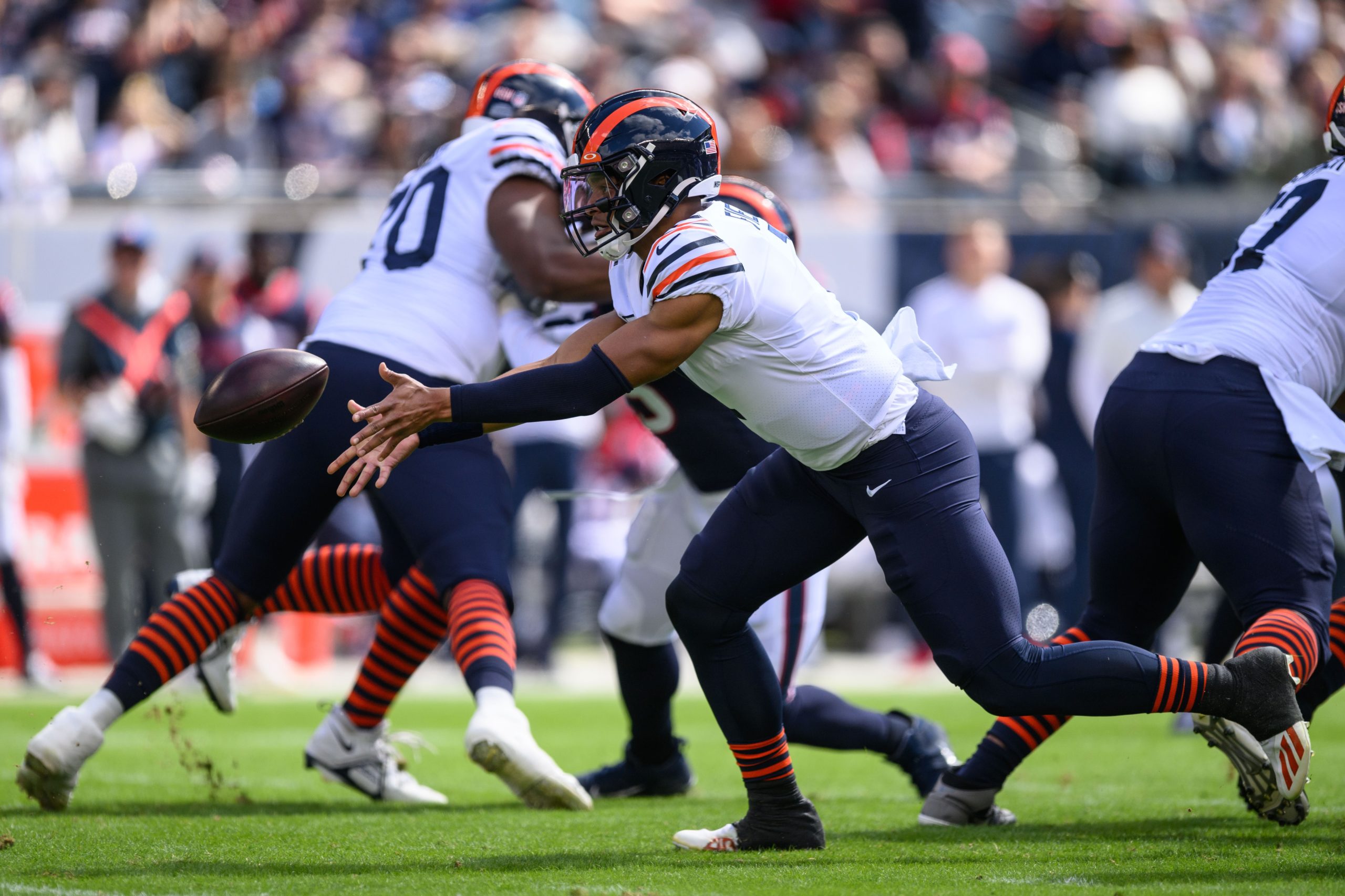 Sep 25, 2022; Chicago, Illinois, USA; Chicago Bears quarterback Justin Fields (1) pitches the ball in the first quarter against the Houston Texans at Soldier Field. Mandatory Credit: Daniel Bartel-USA TODAY Sports