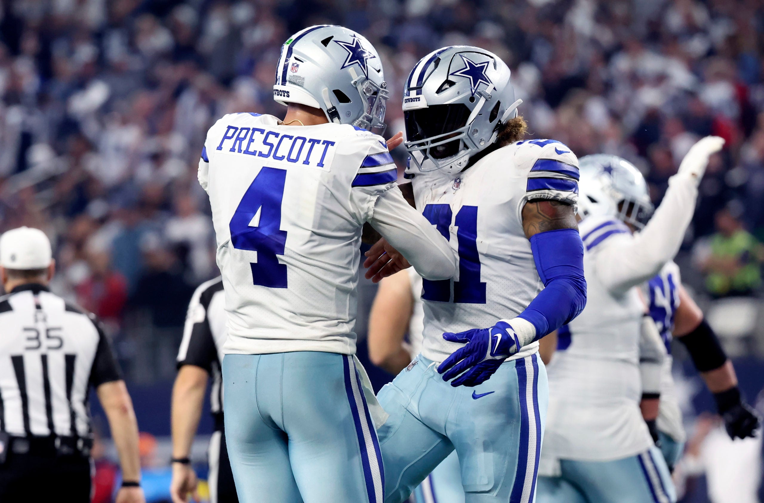 Dec 11, 2022; Arlington, Texas, USA;  Dallas Cowboys running back Ezekiel Elliott (21) celebrates with Dallas Cowboys quarterback Dak Prescott (4) after scoring a touchdown  during the fourth quarter against the Houston Texansat AT&T Stadium. Mandatory Credit: Kevin Jairaj-USA TODAY Sports