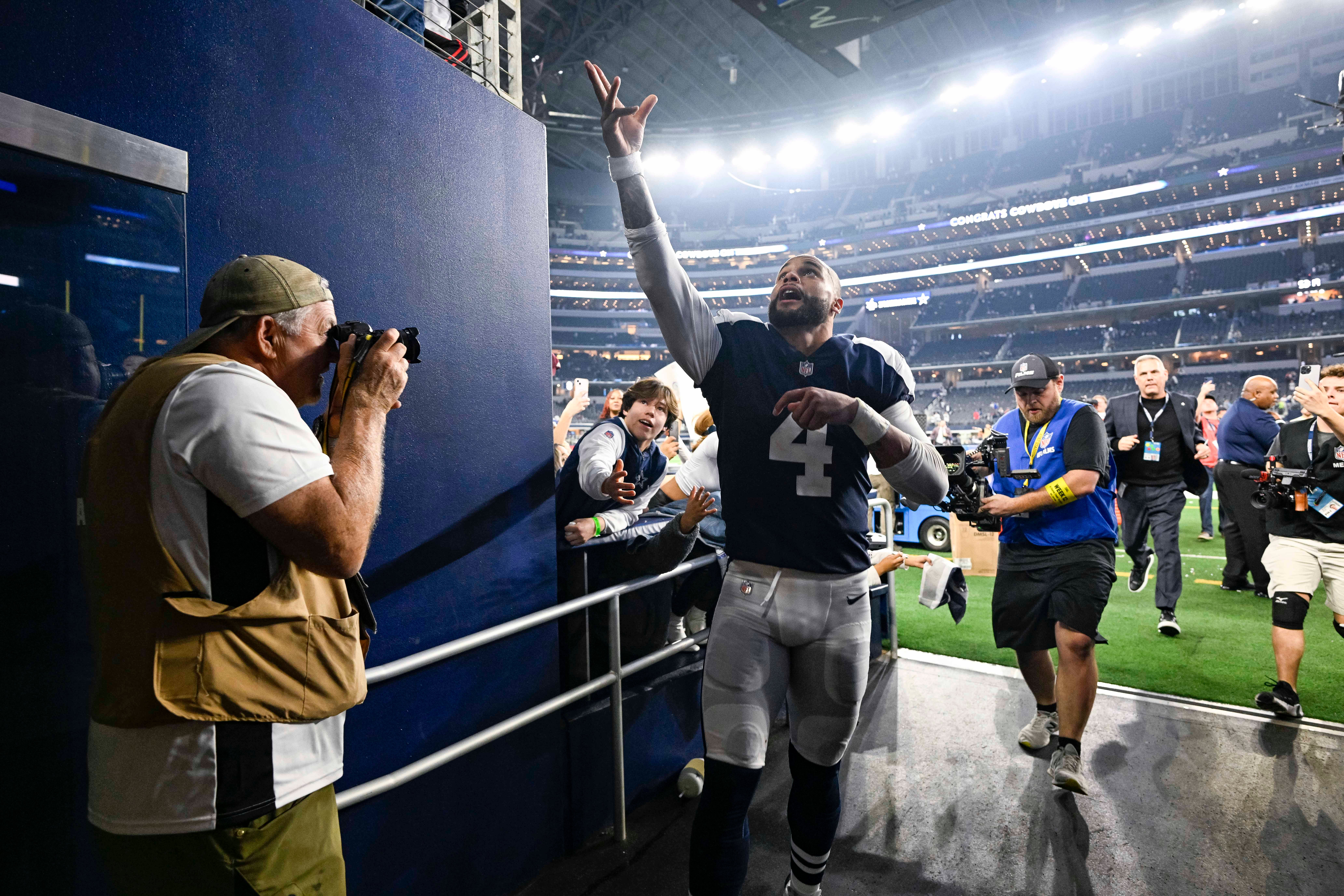 Nov 24, 2022; Arlington, Texas, USA; Dallas Cowboys quarterback Dak Prescott (4) tosses his hat to the fans as he walks off the field after the game between the Cowboys and the New York Giants at AT&T Stadium. Mandatory Credit: Jerome Miron-USA TODAY Sports