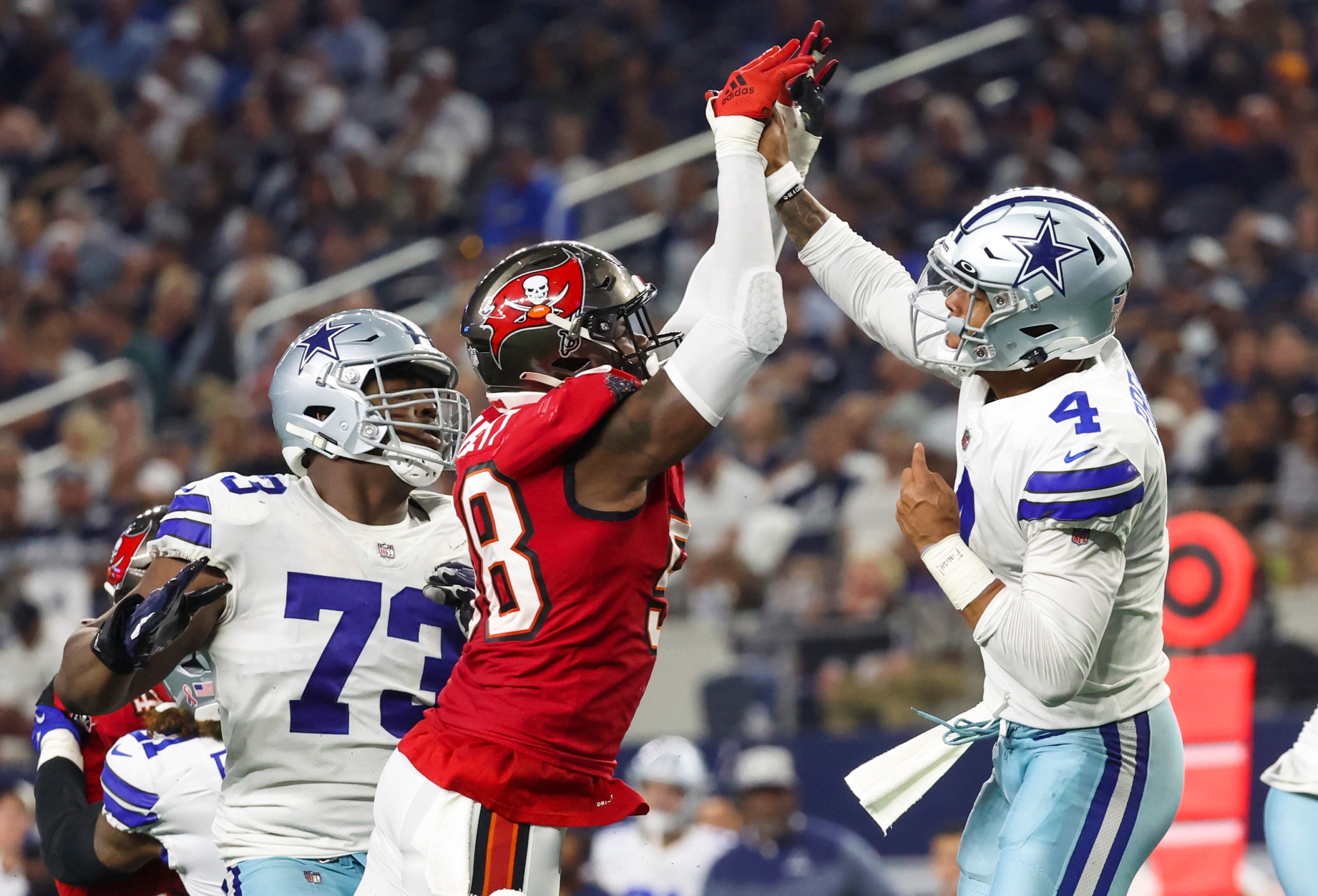 Sep 11, 2022; Arlington, Texas, USA;  Dallas Cowboys quarterback Dak Prescott (4) hits his hand against Tampa Bay Buccaneers linebacker Shaquil Barrett (58) while throwing during the fourth quarter at AT&T Stadium. Mandatory Credit: Kevin Jairaj-USA TODAY Sports