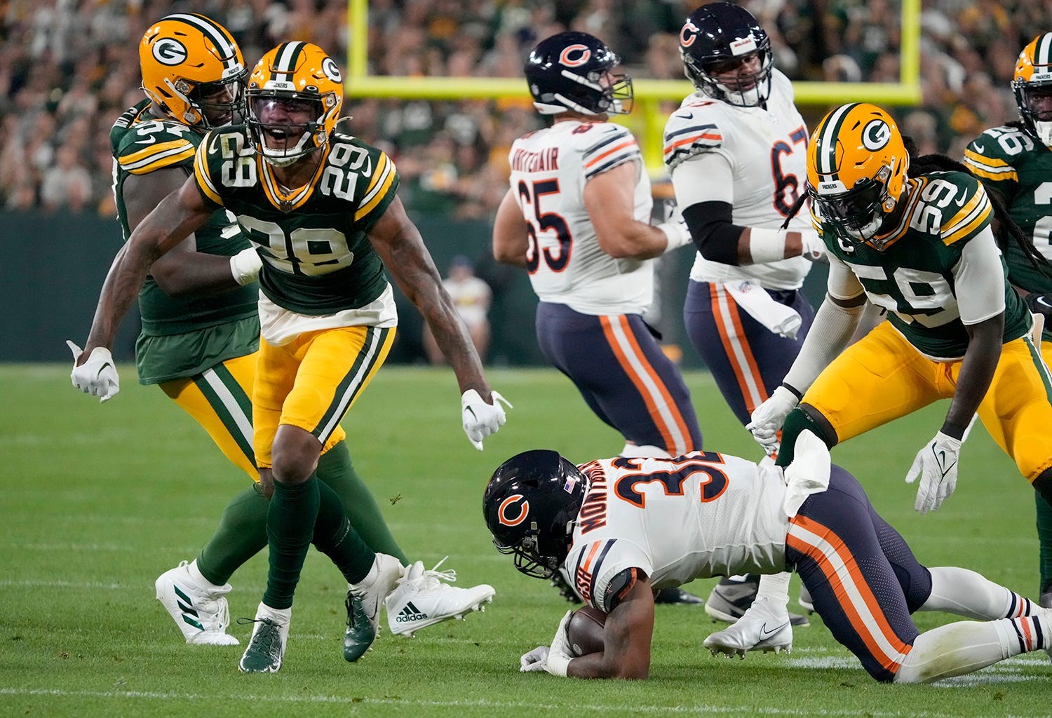 Green Bay Packers cornerback Rasul Douglas (29) celebrate a tackle for a loss on Chicago Bears running back David Montgomery (32) during the second quarter of their game on Sunday, Sept. 18, 2022 at Lambeau Field in Green Bay. Packers Bears Packers19 2066