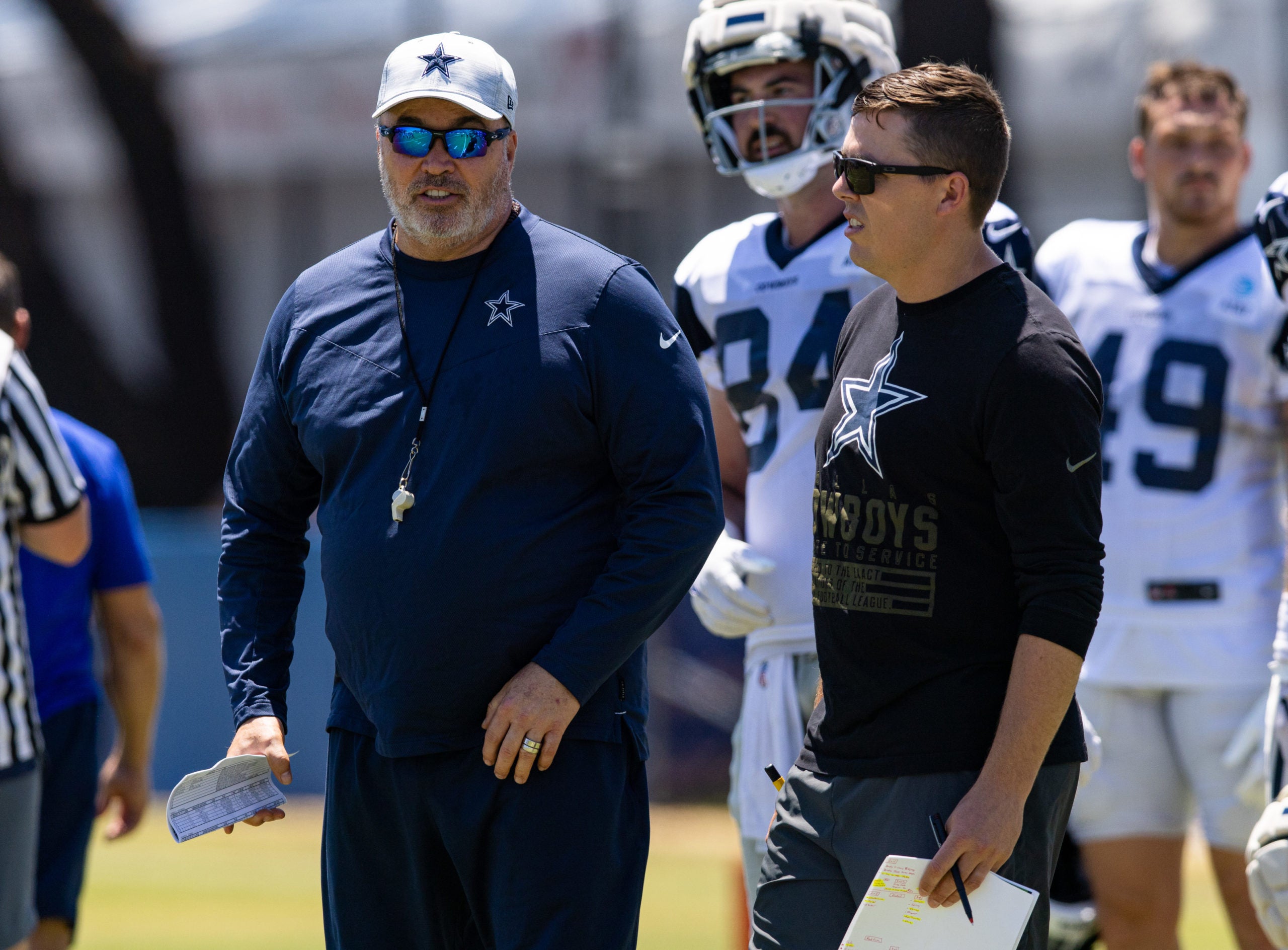 Aug 2, 2022; Oxnard, CA, USA; Dallas Cowboys offensive coordinator Kellen Moore (right) and head coach Mike McCarthy during training camp at River Ridge Playing Fields in Oxnard, California. Mandatory Credit: Jason Parkhurst-USA TODAY Sports