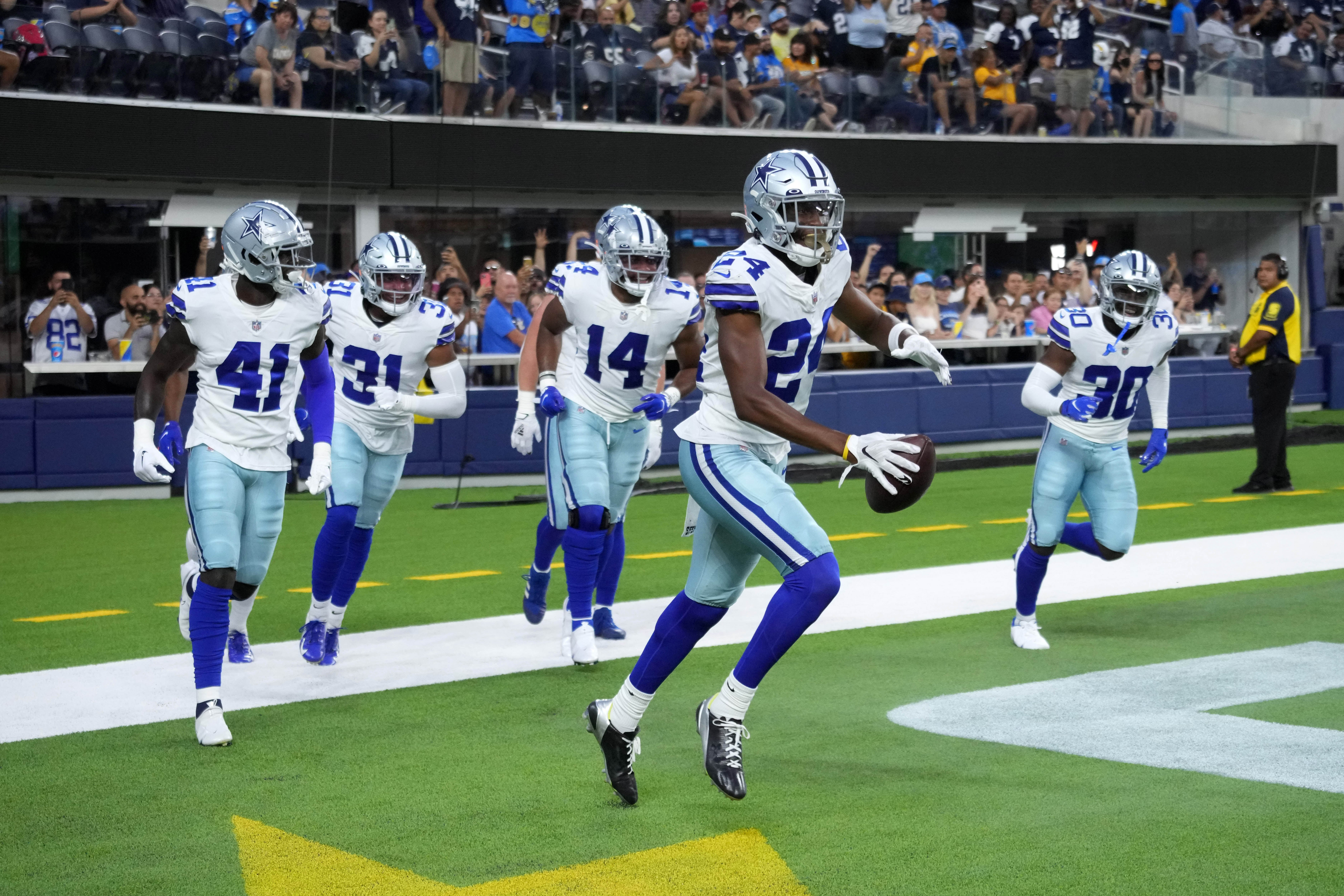 Aug 20, 2022; Inglewood, California, USA; Dallas Cowboys safety Israel Mukuamu (24) celebrates after an interception against the Los Angeles Chargers in the first half  at SoFi Stadium. Mandatory Credit: Kirby Lee-USA TODAY Sports