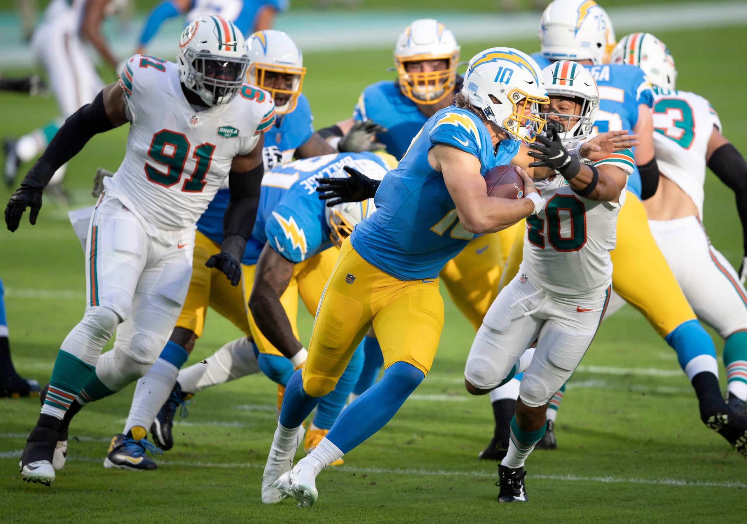 Los Angeles Chargers quarterback Justin Herbert (10) is sacked by Miami Dolphins defensive back Nik Needham (40) at Hard Rock Stadium in Miami Gardens, November 15, 2020.  (ALLEN EYESTONE / THE PALM BEACH POST)