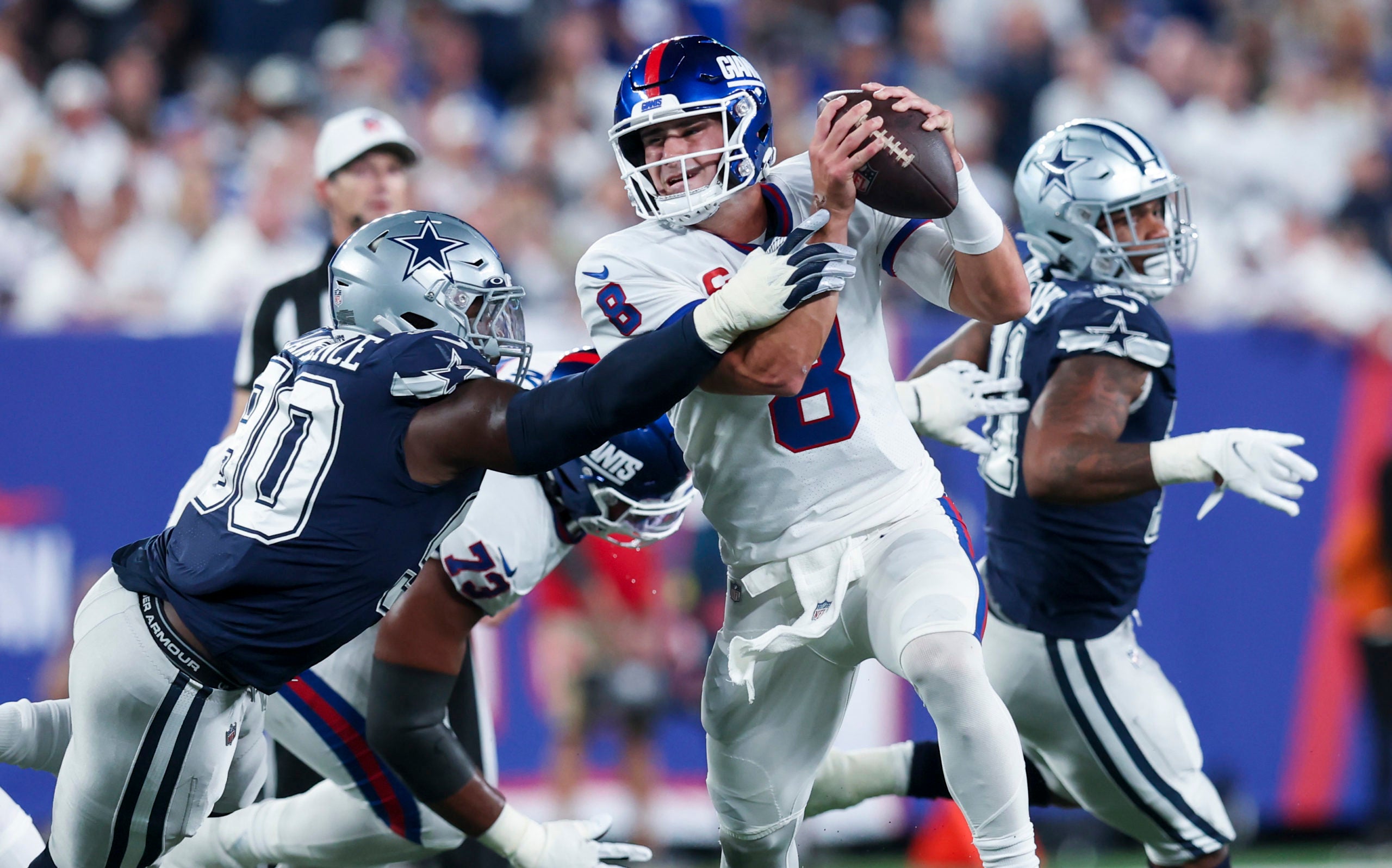 Sep 26, 2022; East Rutherford, New Jersey, USA;  New York Giants quarterback Daniel Jones (8) tries to pass as Dallas Cowboys defensive end DeMarcus Lawrence (90) rushes during the first quarter at MetLife Stadium. Mandatory Credit: Brad Penner-USA TODAY Sports