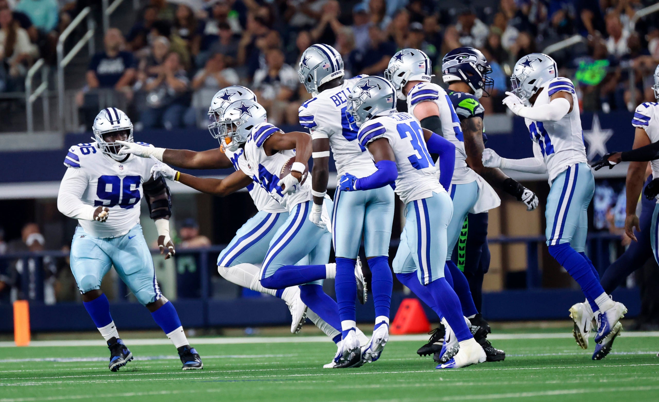 Aug 26, 2022; Arlington, Texas, USA;  Dallas Cowboys safety Israel Mukuamu (24) celebrates with teammates after making an interception during the first quarter against the Seattle Seahawks at AT&T Stadium. Mandatory Credit: Kevin Jairaj-USA TODAY Sports