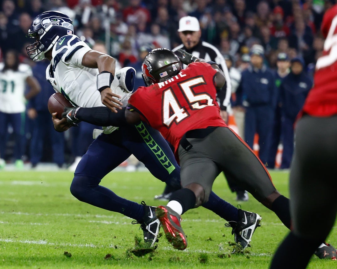 Nov 13, 2022; Munich, Germany, DEU; Tampa Bay Buccaneers linebacker Devin White (45) sacks Seattle Seahawks quarterback Geno Smith (7) and causes a fumble during the third quarter of an International Series game at Allianz Arena. Mandatory Credit: Douglas DeFelice-USA TODAY Sports