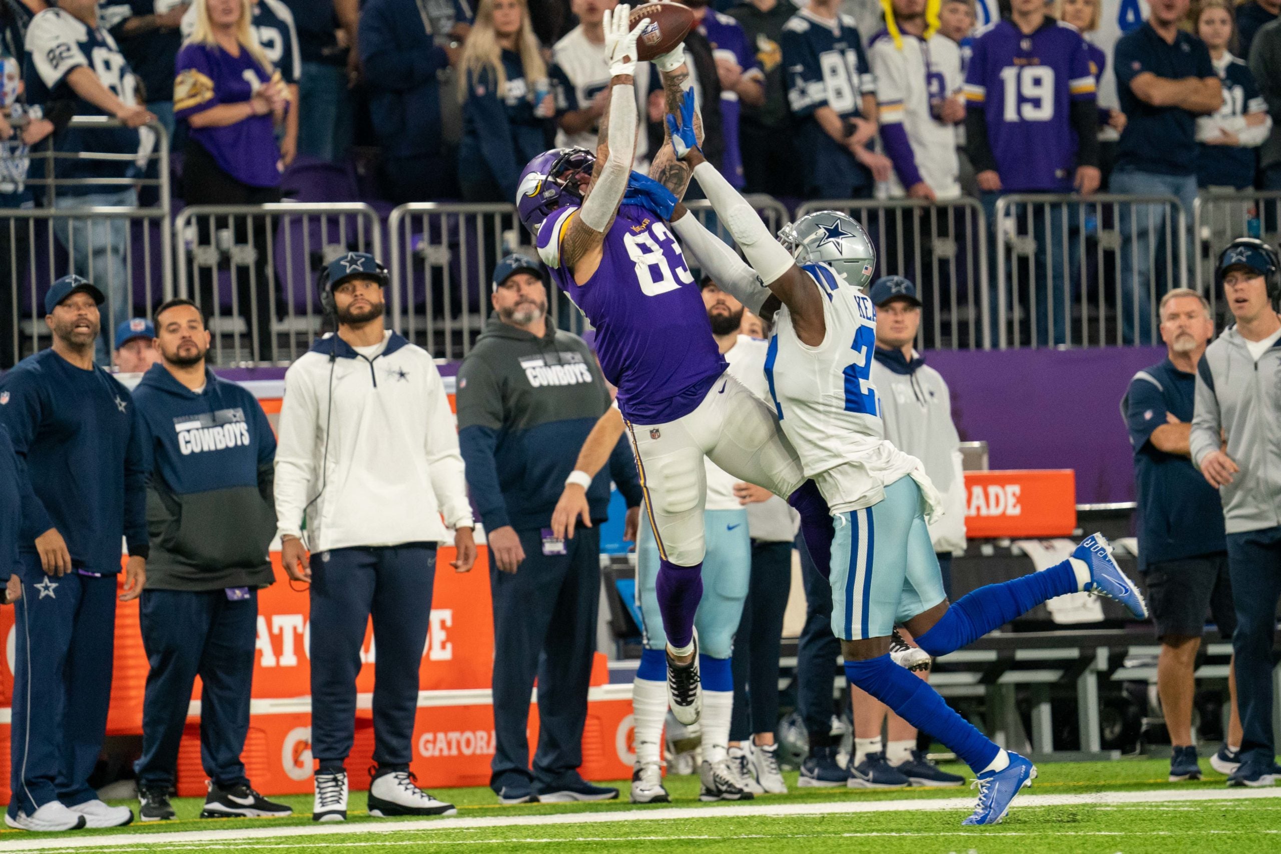 Oct 31, 2021; Minneapolis, Minnesota, USA; Minnesota Vikings tight end Tyler Conklin (83) catches a pass over Dallas Cowboys safety Jayron Kearse (27) in the first quarter as quarterback Dak Prescott (4) and head coach Mike McCarthy look on from the sidelines at U.S. Bank Stadium. Mandatory Credit: Matt Blewett-USA TODAY Sports
