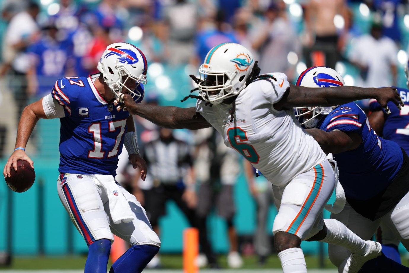 Sep 25, 2022; Miami Gardens, Florida, USA; Miami Dolphins linebacker Melvin Ingram (6) reaches for Buffalo Bills quarterback Josh Allen (17) during the second half at Hard Rock Stadium. Mandatory Credit: Jasen Vinlove-USA TODAY Sports
