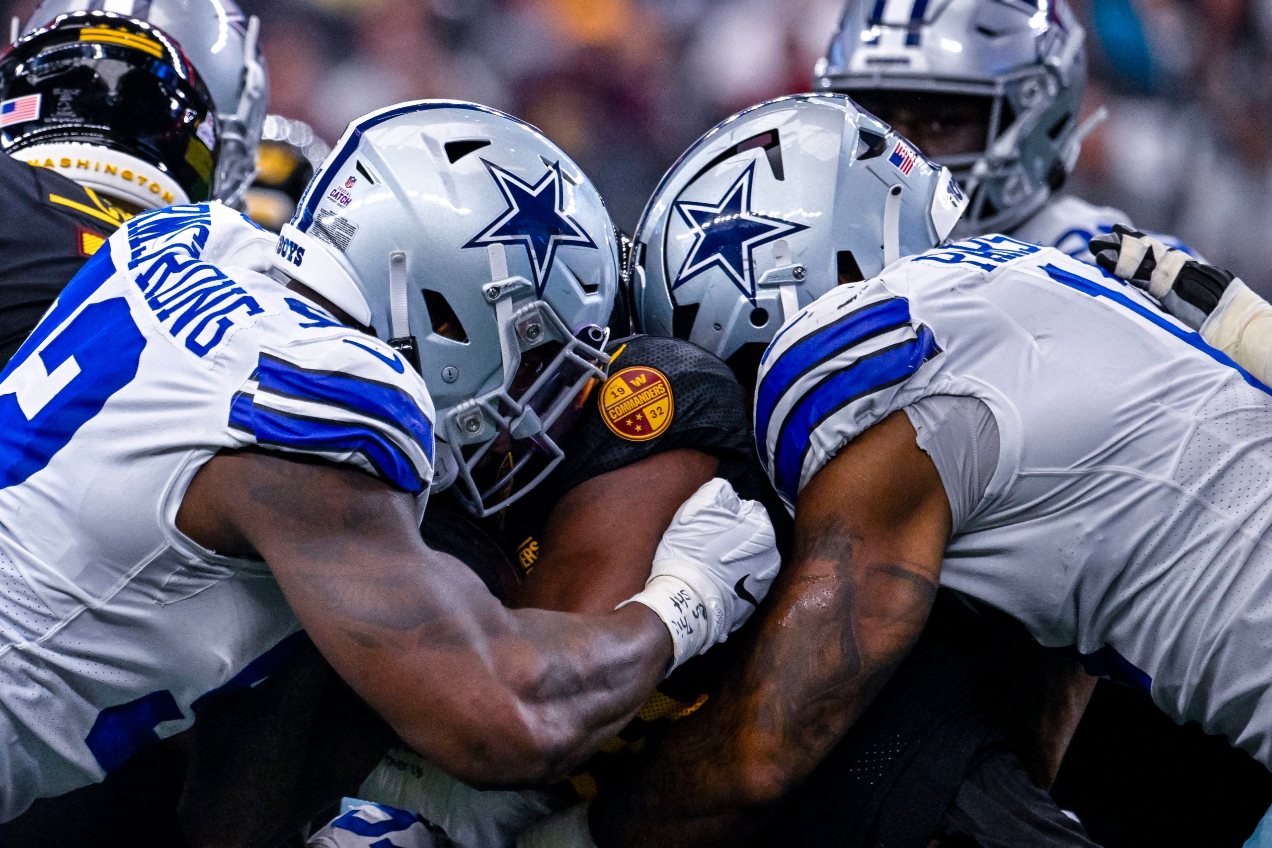 Oct 2, 2022; Arlington, Texas, USA; Dallas Cowboys defensive end Dorance Armstrong (92) and linebacker Micah Parsons (11) tackle Washington Commanders running back Antonio Gibson (24) during the game between the Dallas Cowboys and the Washington Commanders AT&T Stadium. Mandatory Credit: Jerome Miron-USA TODAY Sports
