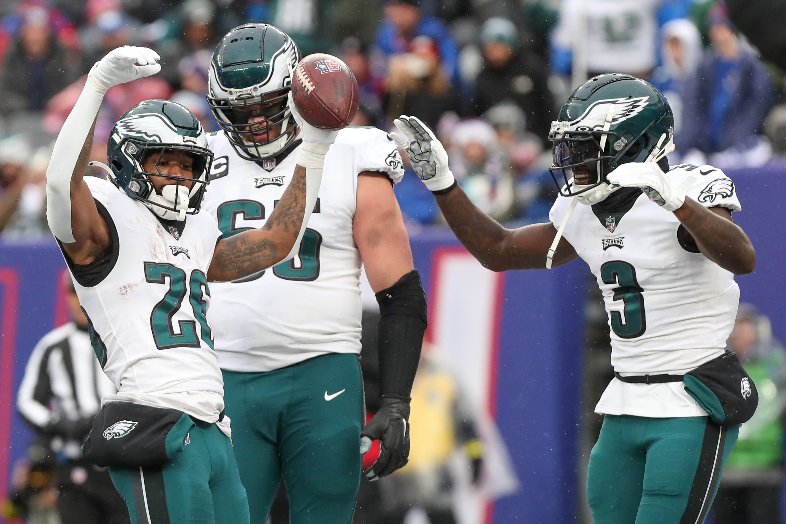 Dec 11, 2022; East Rutherford, New Jersey, USA; Philadelphia Eagles running back Miles Sanders (26) celebrates with wide receiver Zach Pascal (3) and offensive tackle Lane Johnson (65) after scoring a touchdown against the New York Giants during the first quarter at MetLife Stadium. Mandatory Credit: Tom Horak-USA TODAY Sports