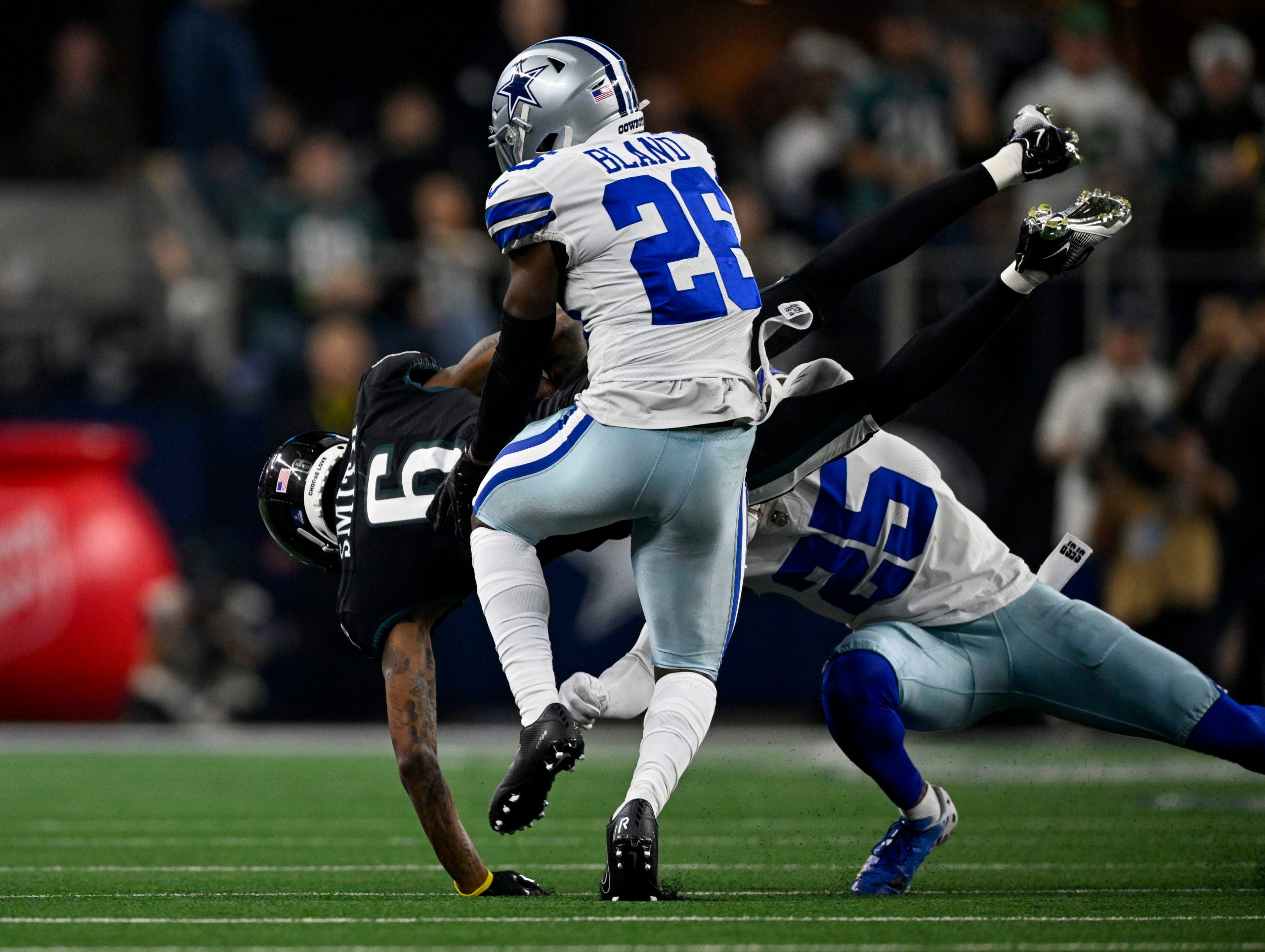 Dec 24, 2022; Arlington, Texas, USA; Philadelphia Eagles wide receiver DeVonta Smith (6) is tackled by Dallas Cowboys cornerback DaRon Bland (26) and cornerback Nahshon Wright (25) during the second half at AT&T Stadium. Mandatory Credit: Jerome Miron-USA TODAY Sports