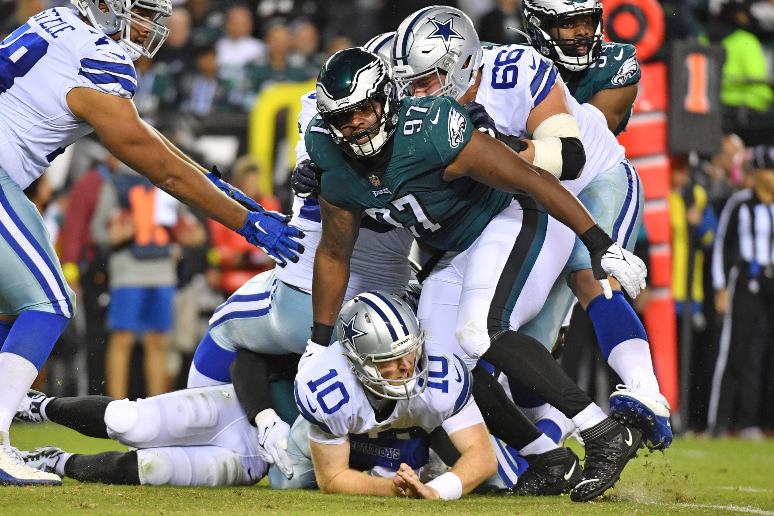 Oct 16, 2022; Philadelphia, Pennsylvania, USA; Dallas Cowboys quarterback Cooper Rush (10) hits the turf after being pressured by Philadelphia Eagles defensive tackle Javon Hargrave (97) during the fourth quarter at Lincoln Financial Field. Mandatory Credit: Eric Hartline-USA TODAY Sports