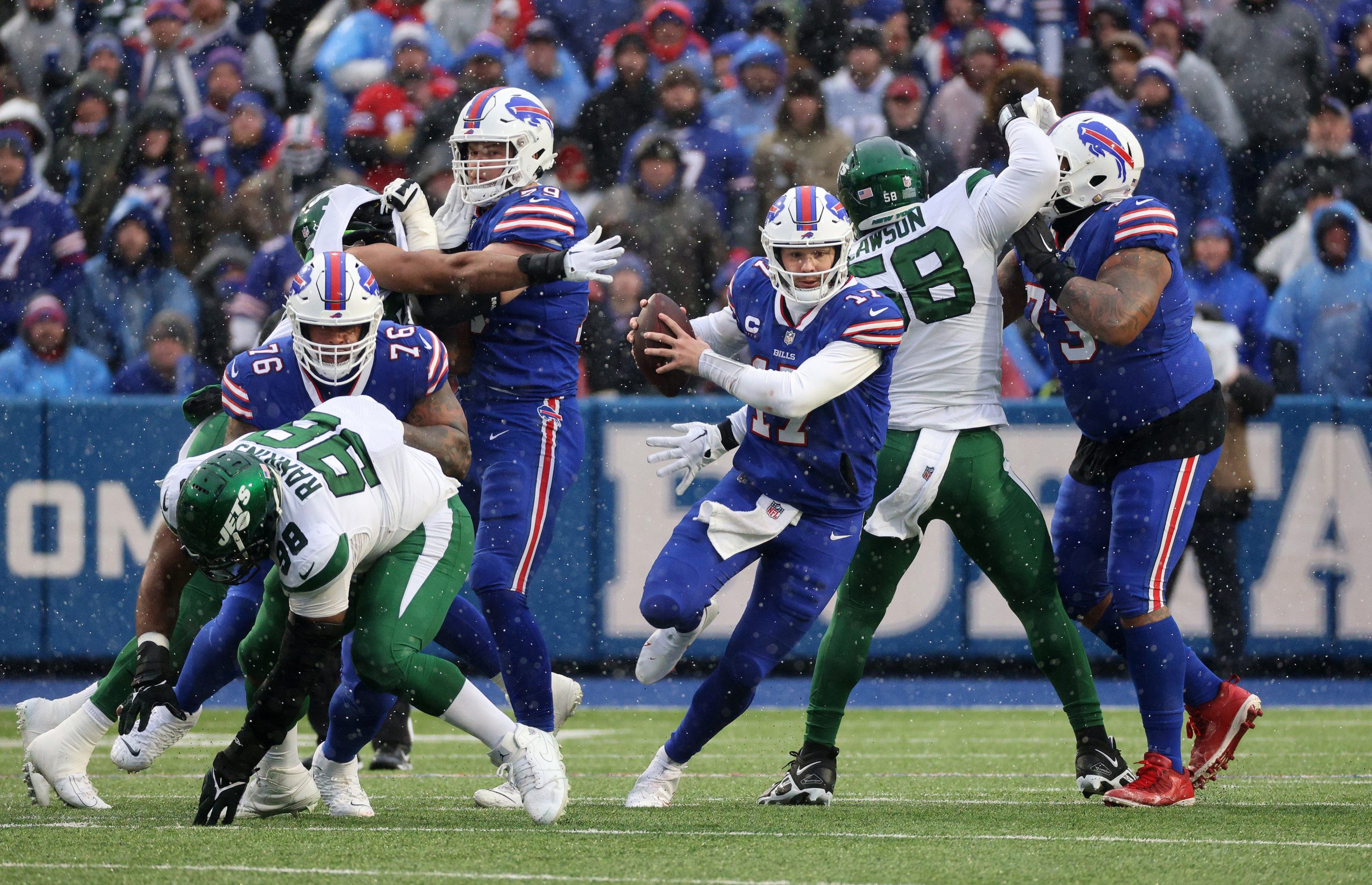 Bills quarterback Josh Allen is able to escape as the pocket collapses around him.