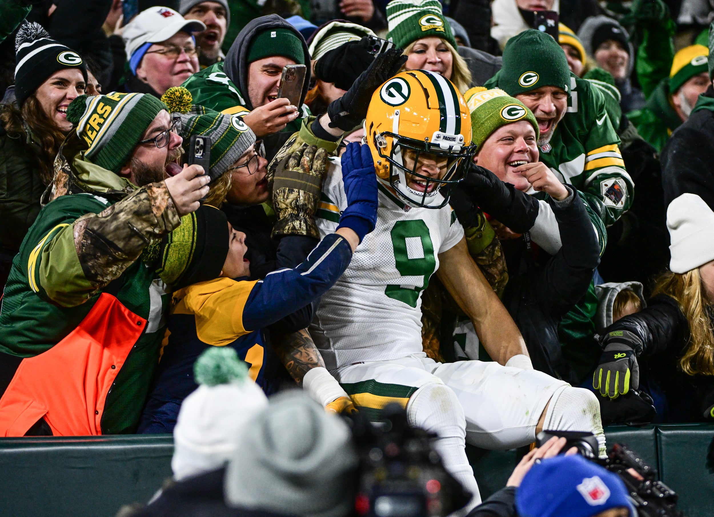 Nov 17, 2022; Green Bay, Wisconsin, USA; Green Bay Packers wide receiver Christian Watson (9) celebrates with fans after catching a touchdown in the third quarter at Lambeau Field. Mandatory Credit: Benny Sieu-USA TODAY Sports
