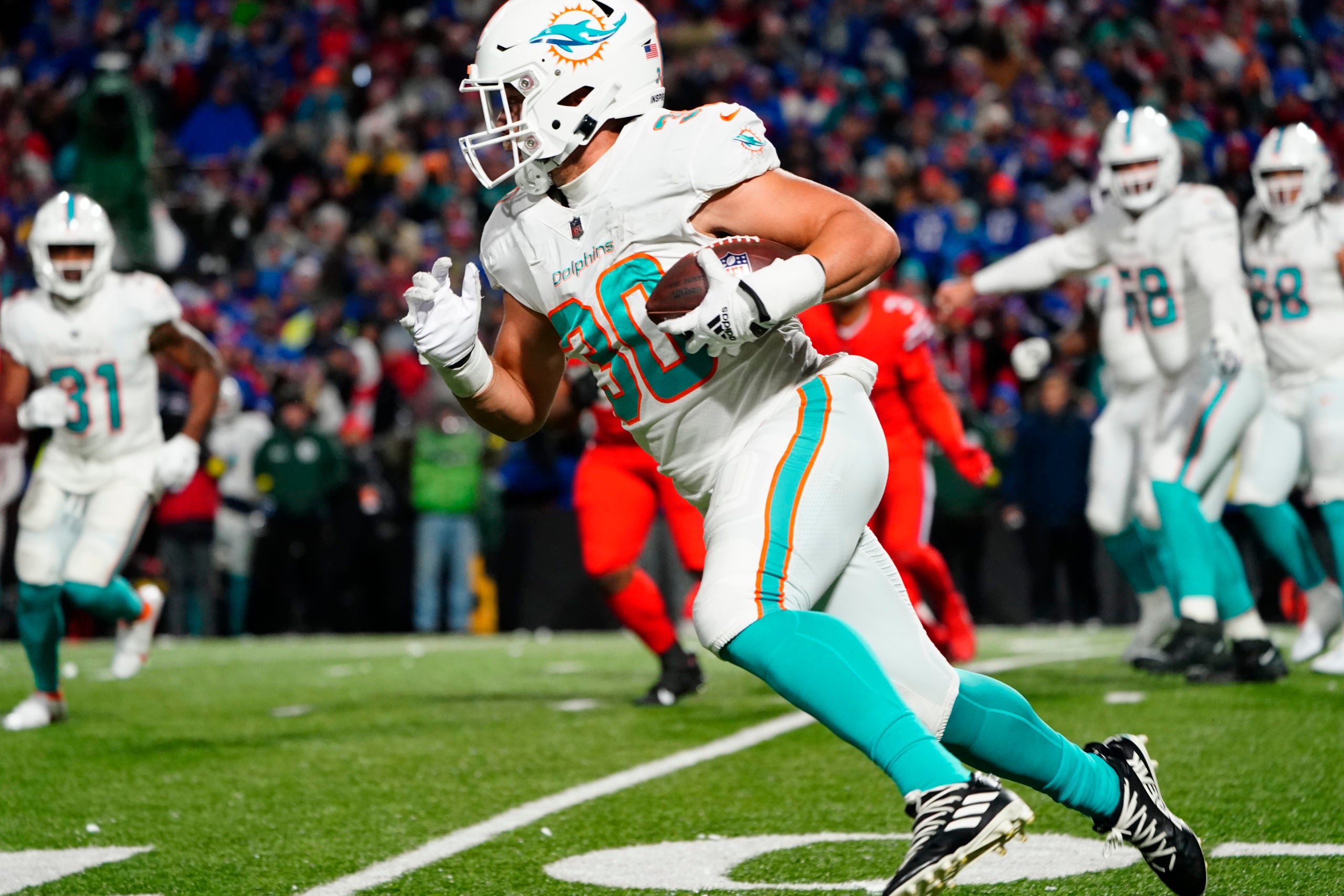 Dec 17, 2022; Orchard Park, New York, USA; Miami Dolphins full back Alec Ingold (30) runs with the ball against the Buffalo Bills during the second half at Highmark Stadium. Mandatory Credit: Gregory Fisher-USA TODAY Sports