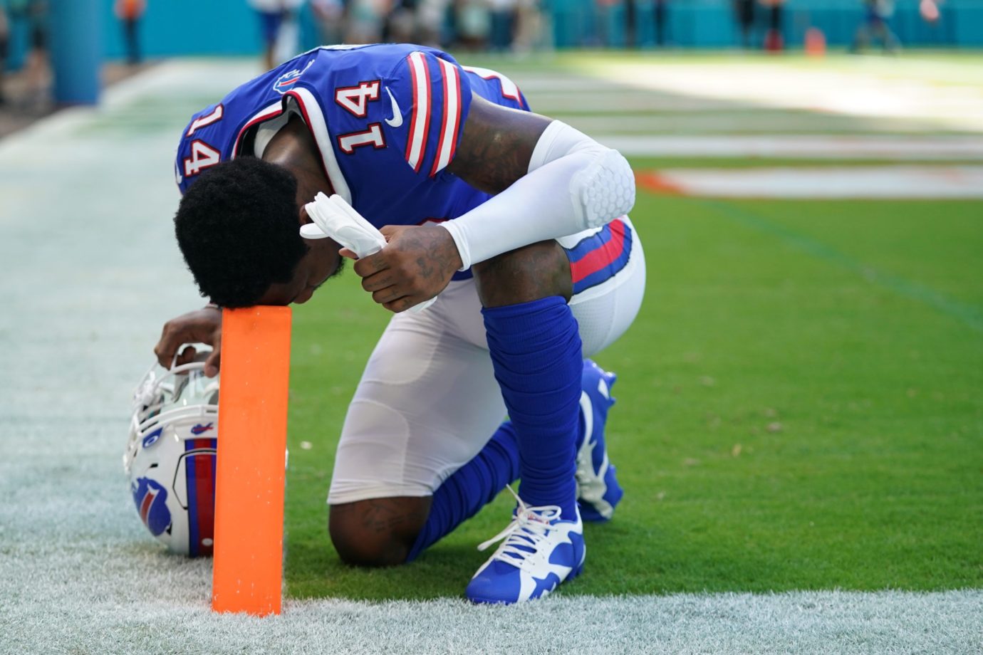 Sep 25, 2022; Miami Gardens, Florida, USA; Buffalo Bills wide receiver Stefon Diggs (14) kneels in the end zone resting his head on a pylon prior to the game against the Miami Dolphins at Hard Rock Stadium. Mandatory Credit: Jasen Vinlove-USA TODAY Sports