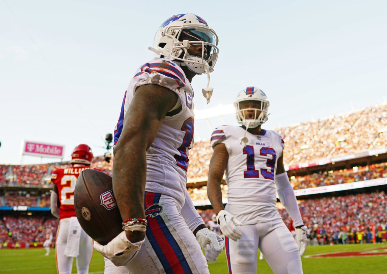 Oct 16, 2022; Kansas City, Missouri, USA; Buffalo Bills wide receiver Stefon Diggs (14) reacts after scoring a touchdown as wide receiver Gabe Davis (13) looks on during the second half against the Kansas City Chiefs at GEHA Field at Arrowhead Stadium. Mandatory Credit: Jay Biggerstaff-USA TODAY Sports