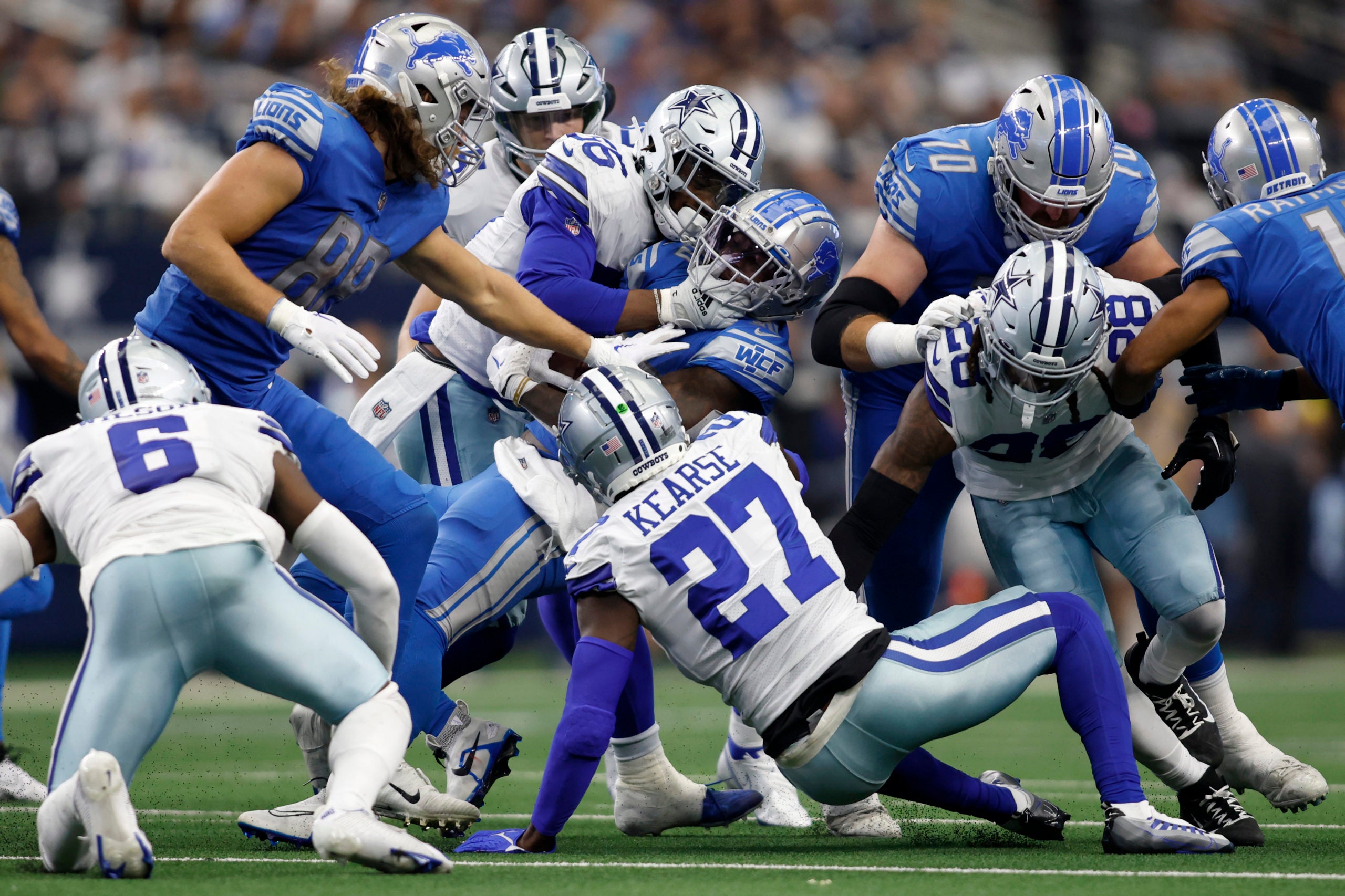 Oct 23, 2022; Arlington, Texas, USA; Detroit Lions running back Jamaal Williams (30) is tackled by Dallas Cowboys defensive end Dante Fowler Jr. (56) in the third quarter at AT&T Stadium. Mandatory Credit: Tim Heitman-USA TODAY Sports
