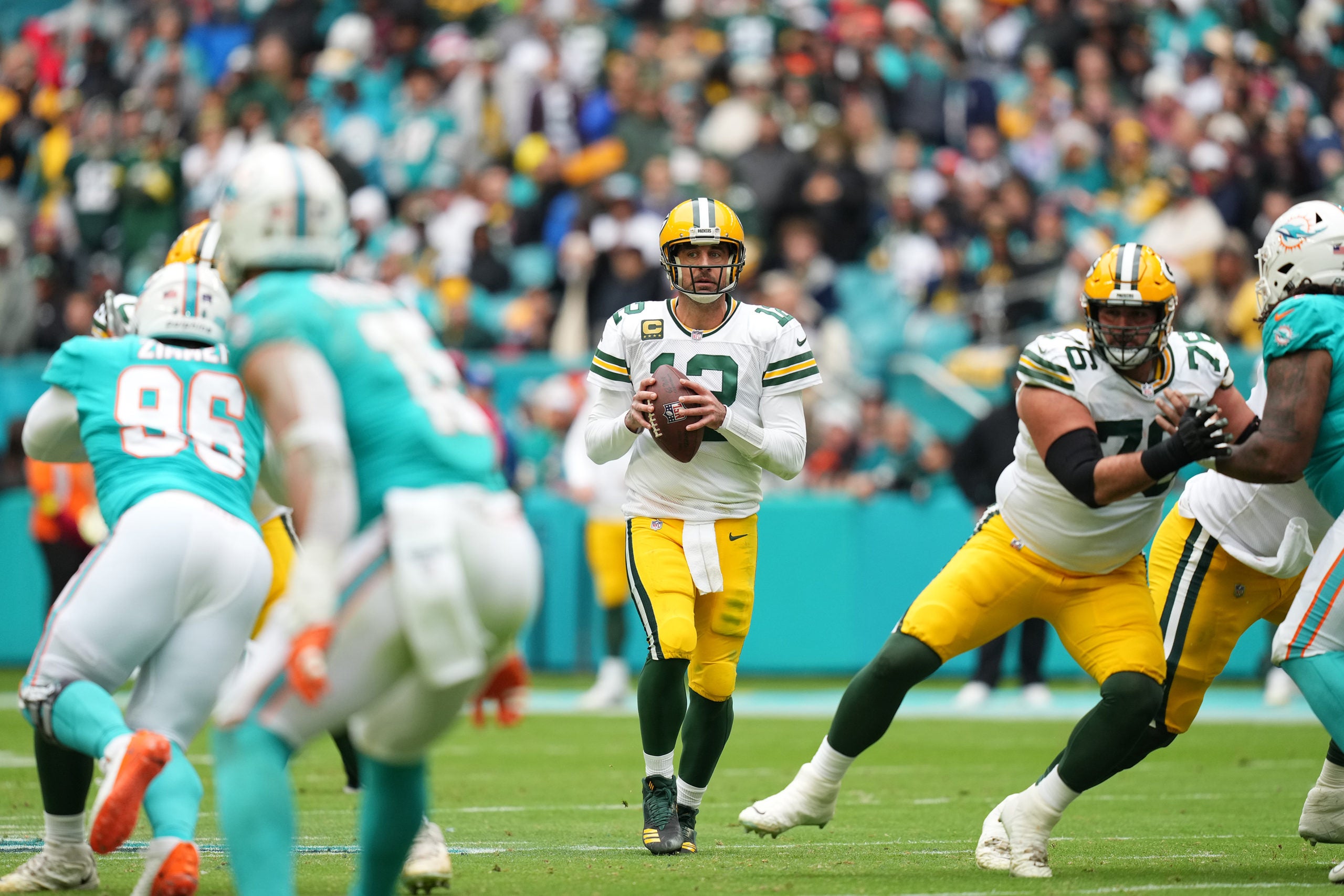 Dec 25, 2022; Miami Gardens, Florida, USA; Green Bay Packers quarterback Aaron Rodgers (12) drops back with the ball before attempting a pass against the Miami Dolphins during the second half at Hard Rock Stadium. Mandatory Credit: Jasen Vinlove-USA TODAY Sports