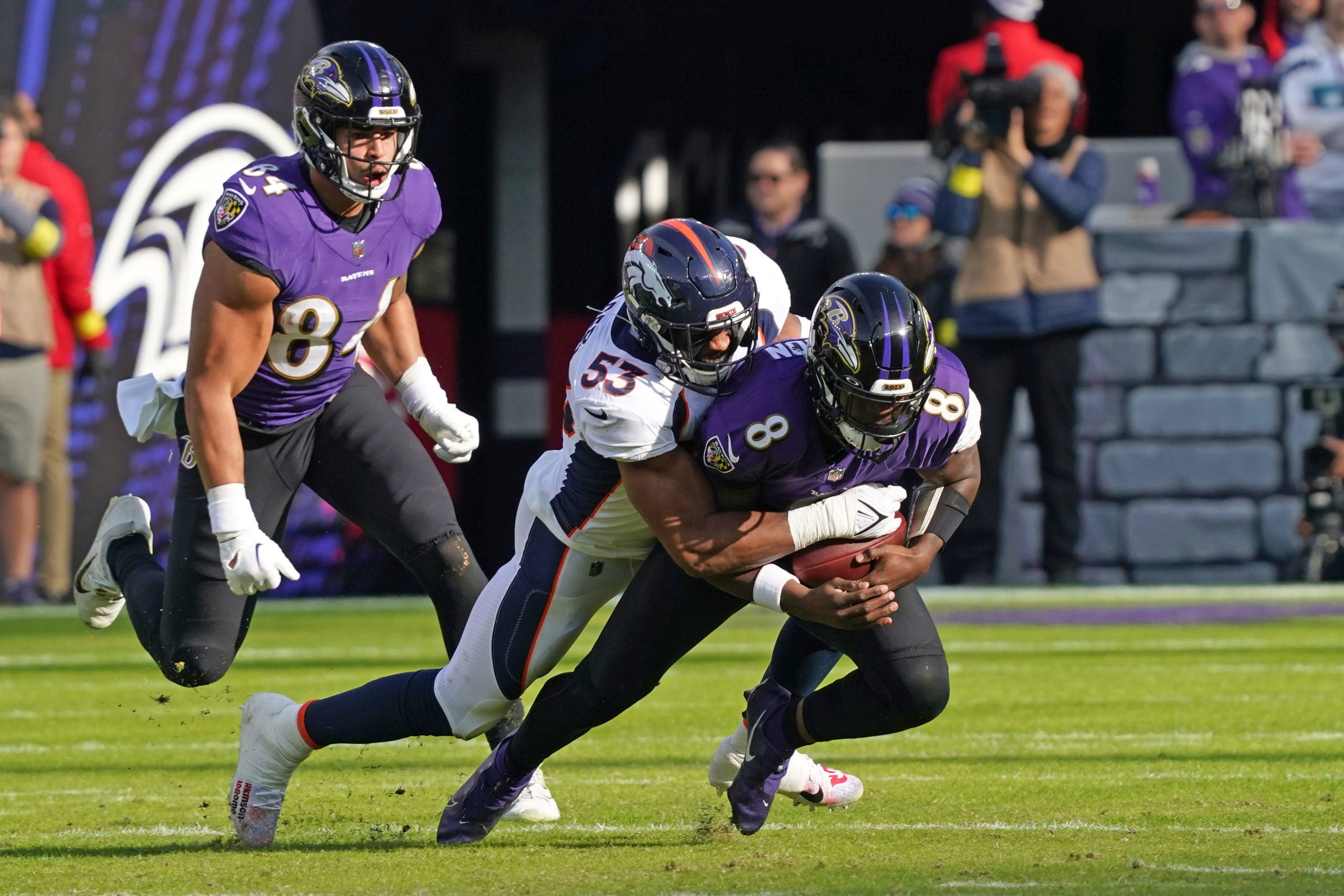 Dec 4, 2022; Baltimore, Maryland, USA; Baltimore Ravens quarterback Lamar Jackson (8) would leave the game after being sacked in the second quarter by Denver Broncos linebacker Jonathon Cooper (53) at M&T Bank Stadium. Mandatory Credit: Mitch Stringer-USA TODAY Sports
