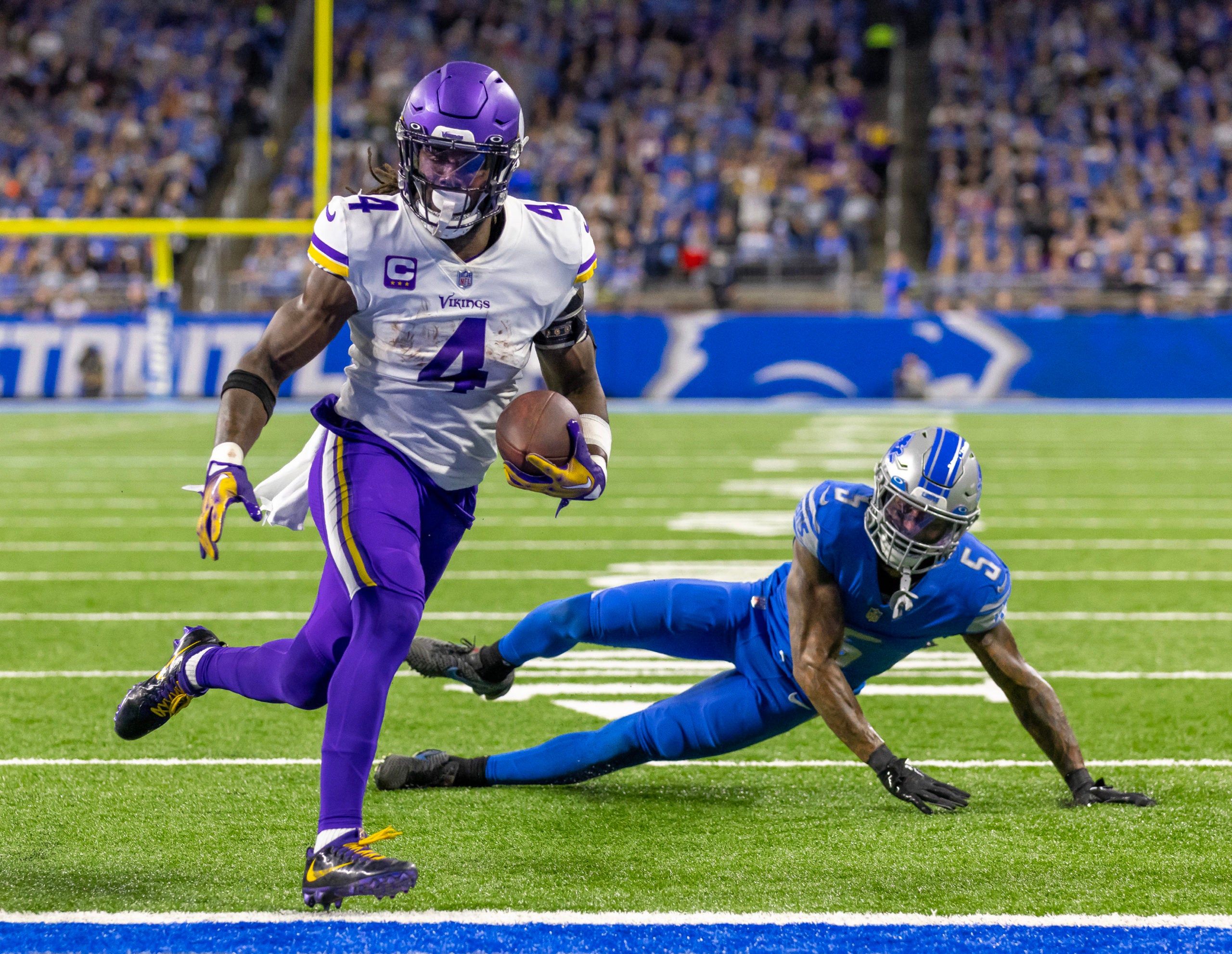 Dec 11, 2022; Detroit, Michigan, USA; Minnesota Vikings running back Dalvin Cook (4) runs with the ball for a touchdown in front of Detroit Lions safety DeShon Elliott (5) during the first quarter at Ford Field. Mandatory Credit: David Reginek-USA TODAY Sports