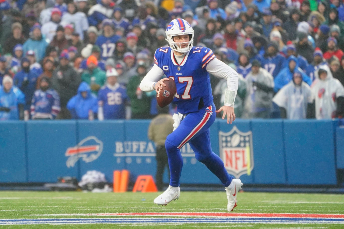 Dec 11, 2022; Orchard Park, New York, USA; Buffalo Bills quarterback Josh Allen (17) rolls out looking to throw the ball against the New York Jets during the first half at Highmark Stadium. Mandatory Credit: Gregory Fisher-USA TODAY Sports