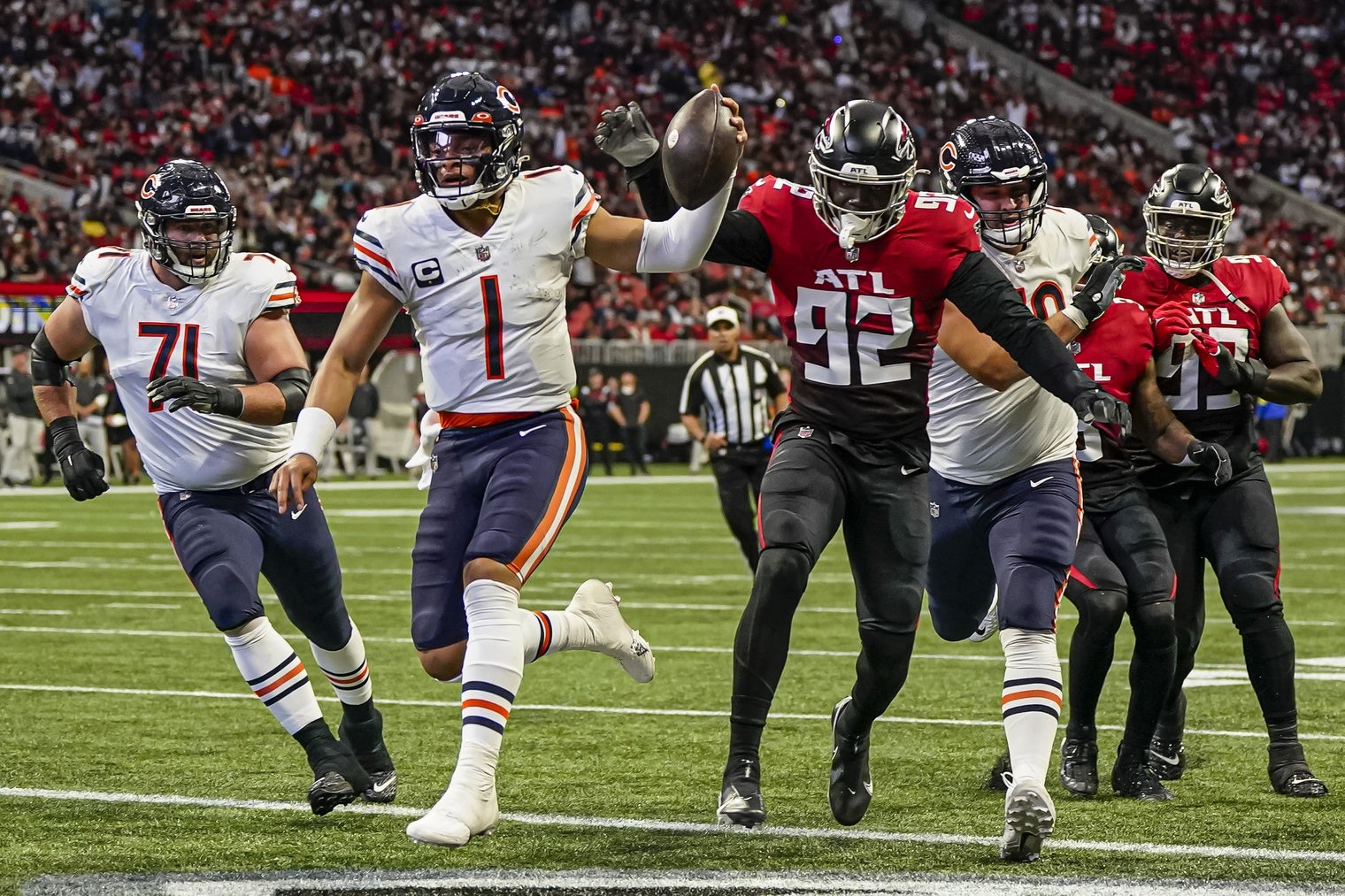 Nov 20, 2022; Atlanta, Georgia, USA; Chicago Bears quarterback Justin Fields (1) runs for a touchdown against the Atlanta Falcons at Mercedes-Benz Stadium. Mandatory Credit: Dale Zanine-USA TODAY Sports