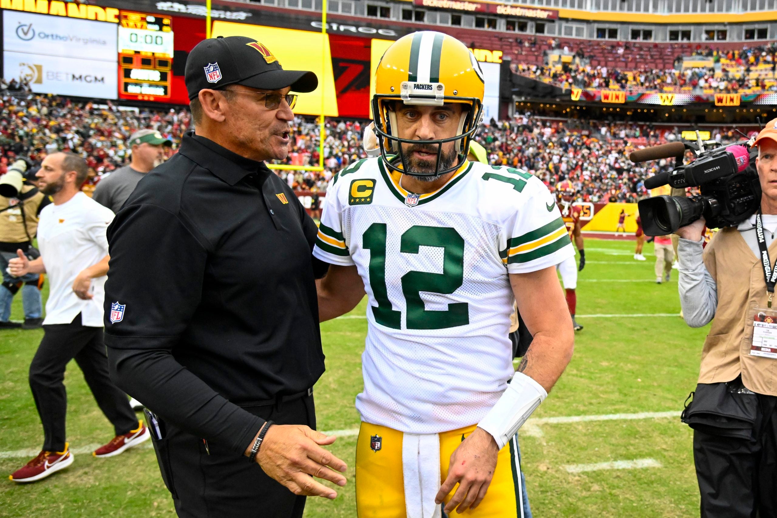 Oct 23, 2022; Landover, Maryland, USA; Washington Commanders head coach Ron Rivera talks with Green Bay Packers quarterback Aaron Rodgers (12) after the game at FedExField. Mandatory Credit: Brad Mills-USA TODAY Sports
